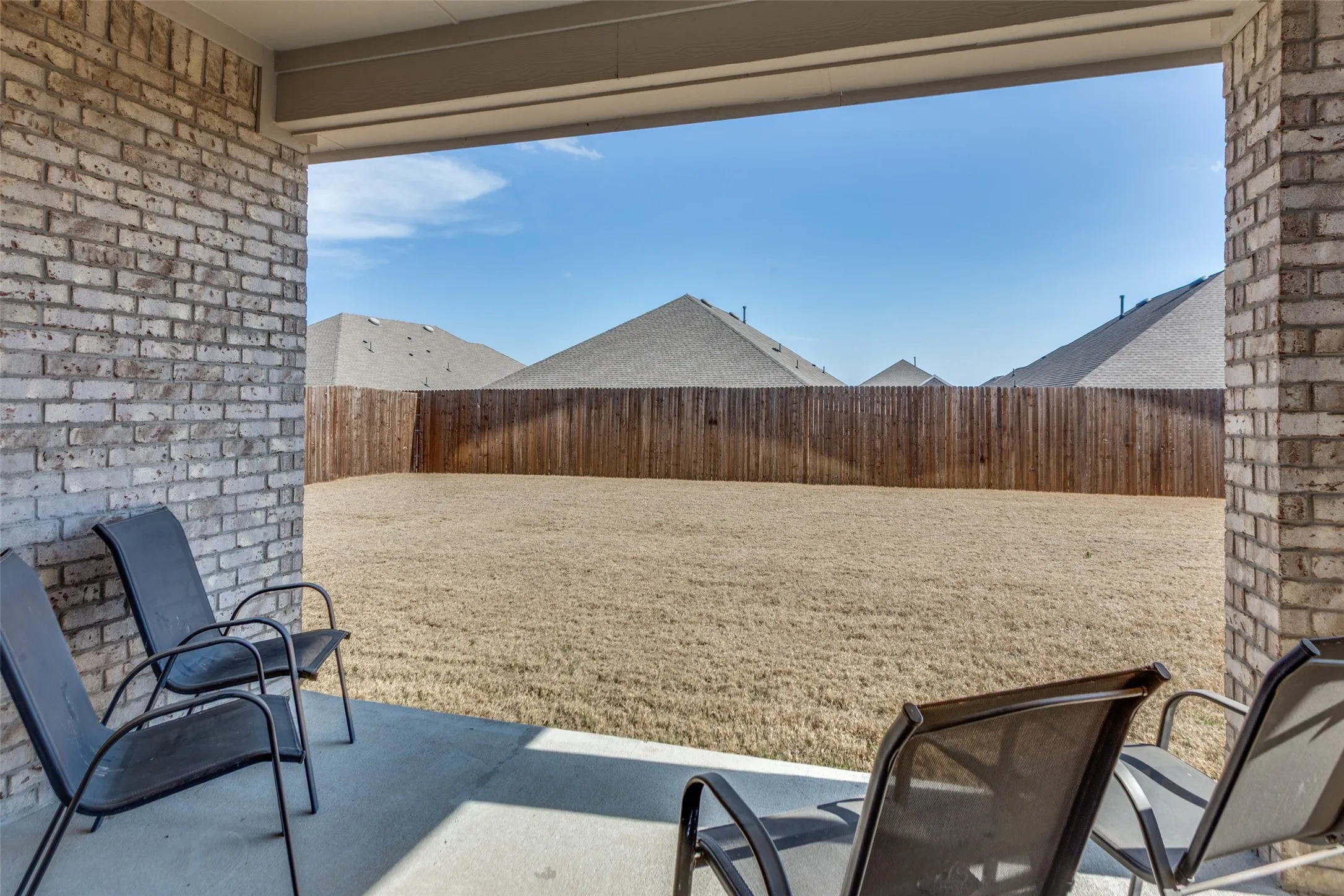 Fenced backyard with a patio area