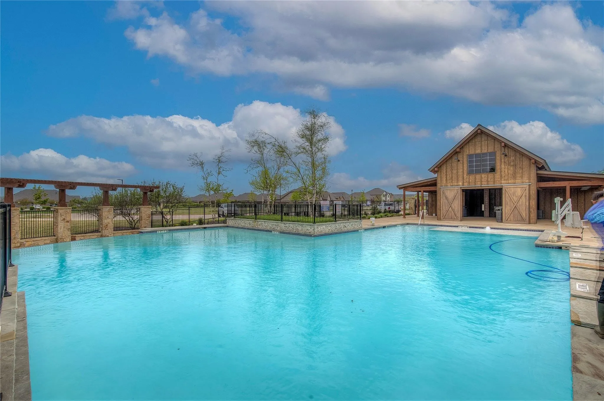 Community pool with a patio