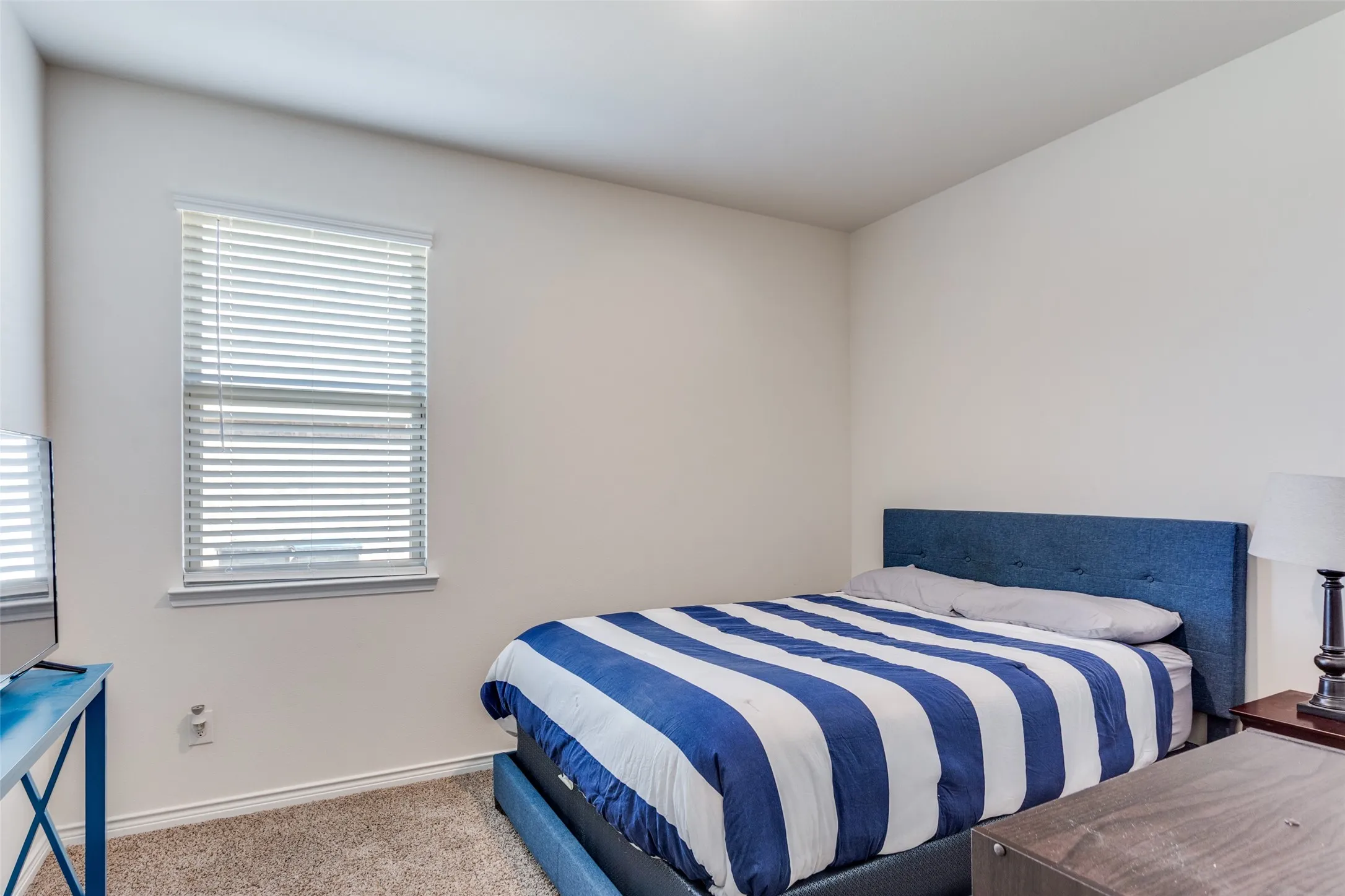 Carpeted bedroom featuring baseboards