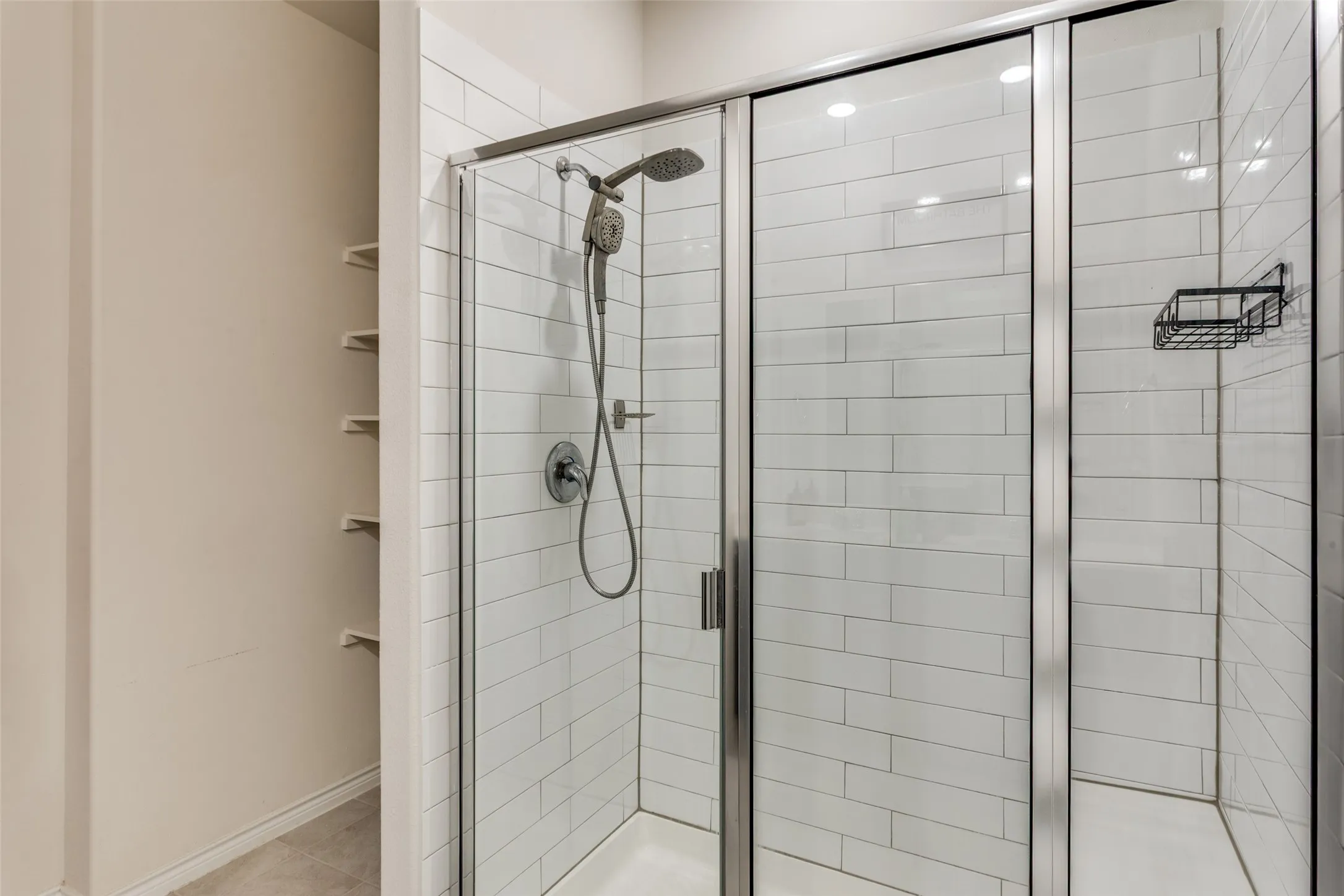 Bathroom with a stall shower and baseboards