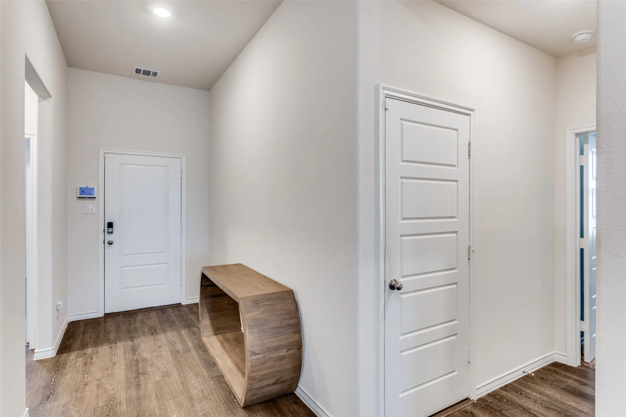 Entryway with light wood-style flooring and baseboards