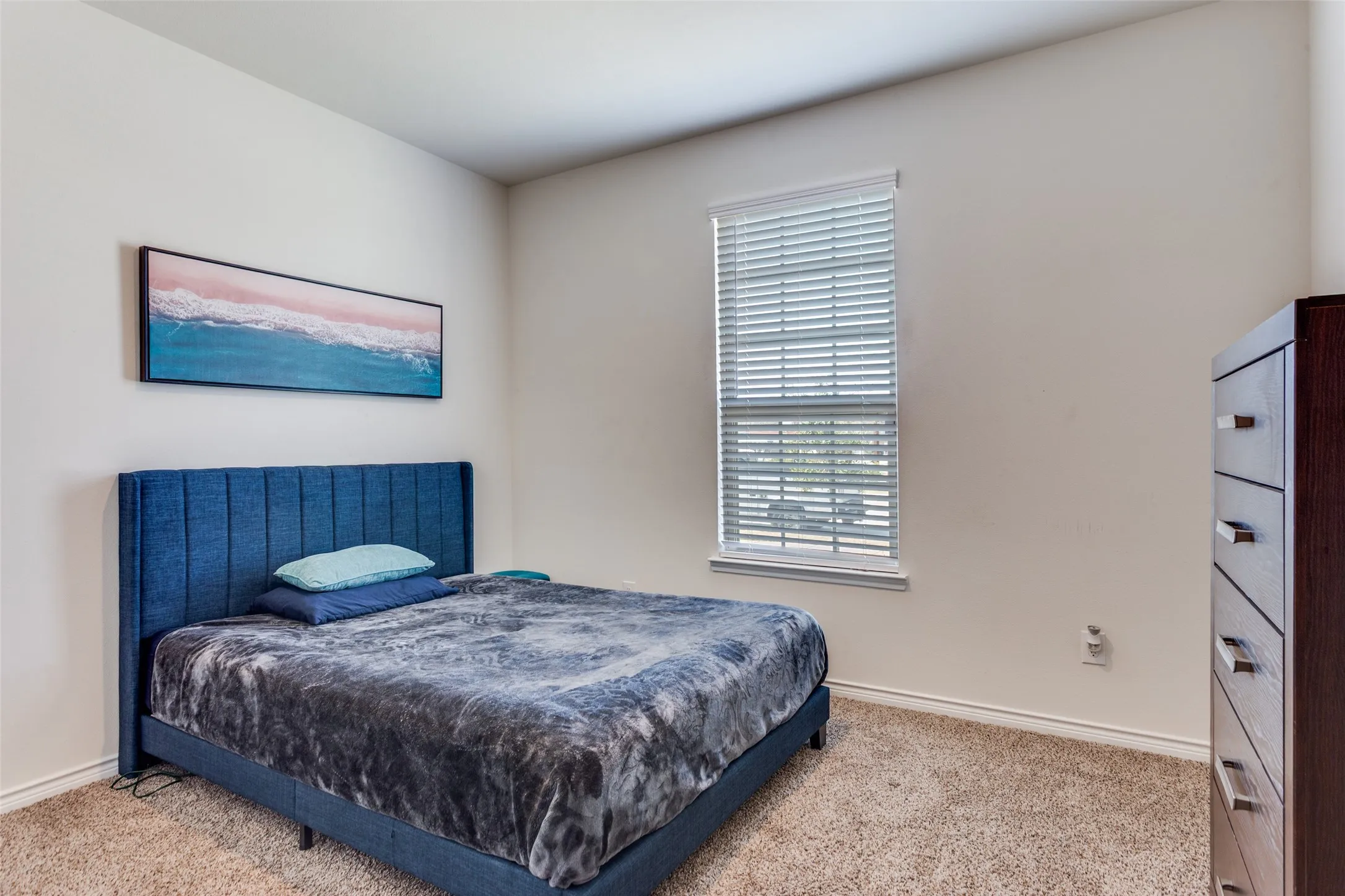 Bedroom featuring light colored carpet and baseboards