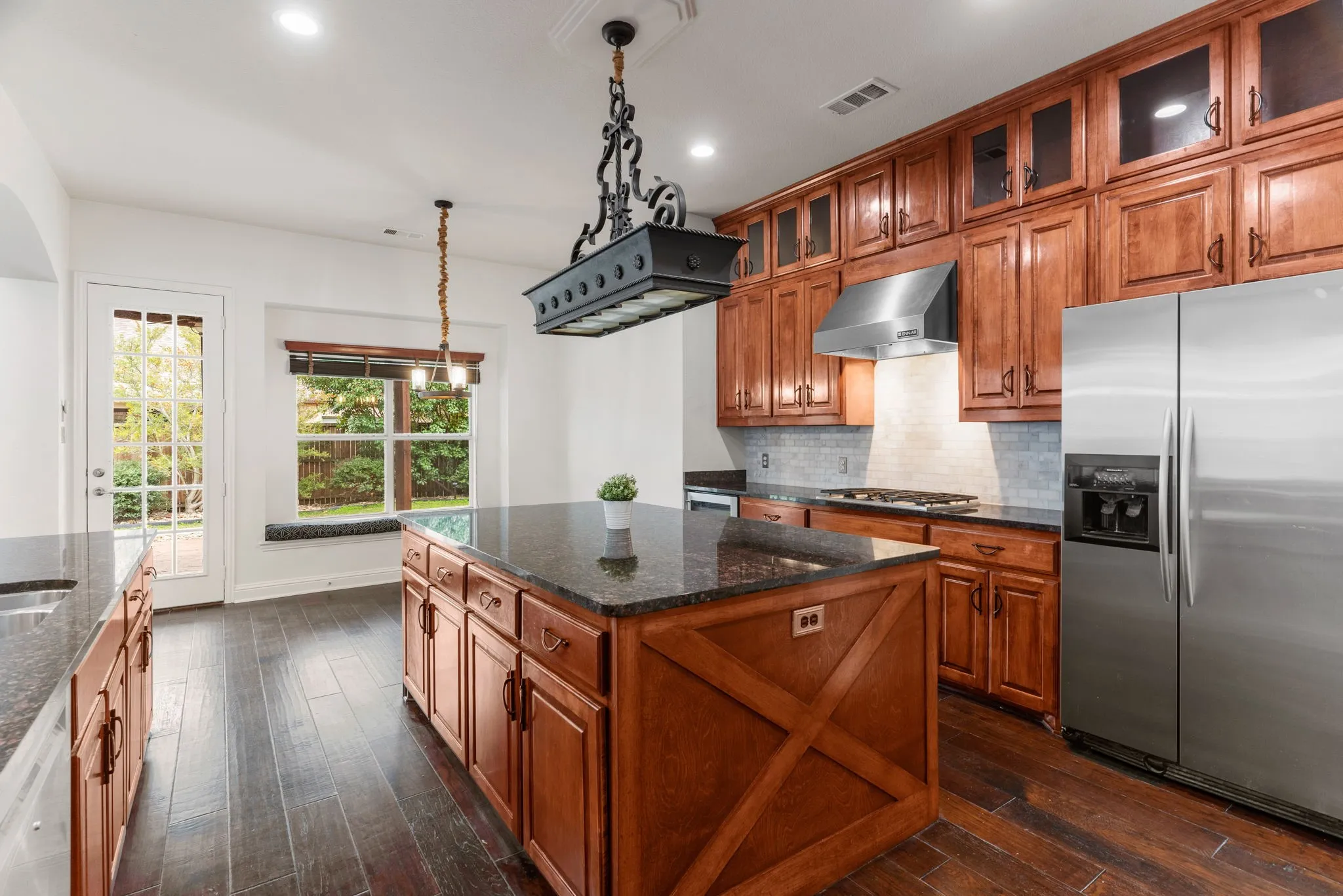 The oversized granite island has awesome storage too. Stainless kitchen appliances including a Bosch dishwasher, GE Monogram wine chiller, gas cooktop & refrigerator.