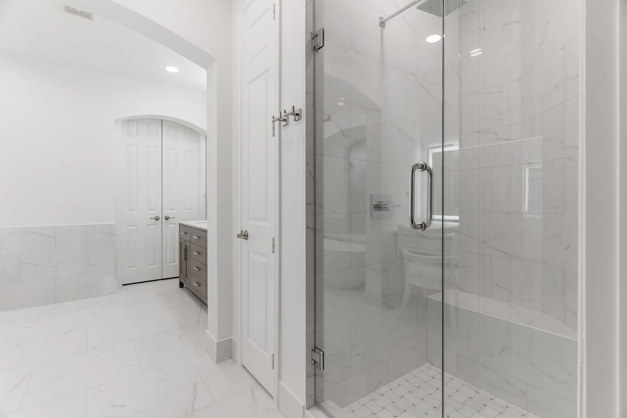 Spacious walk-in shower with bench seat.
