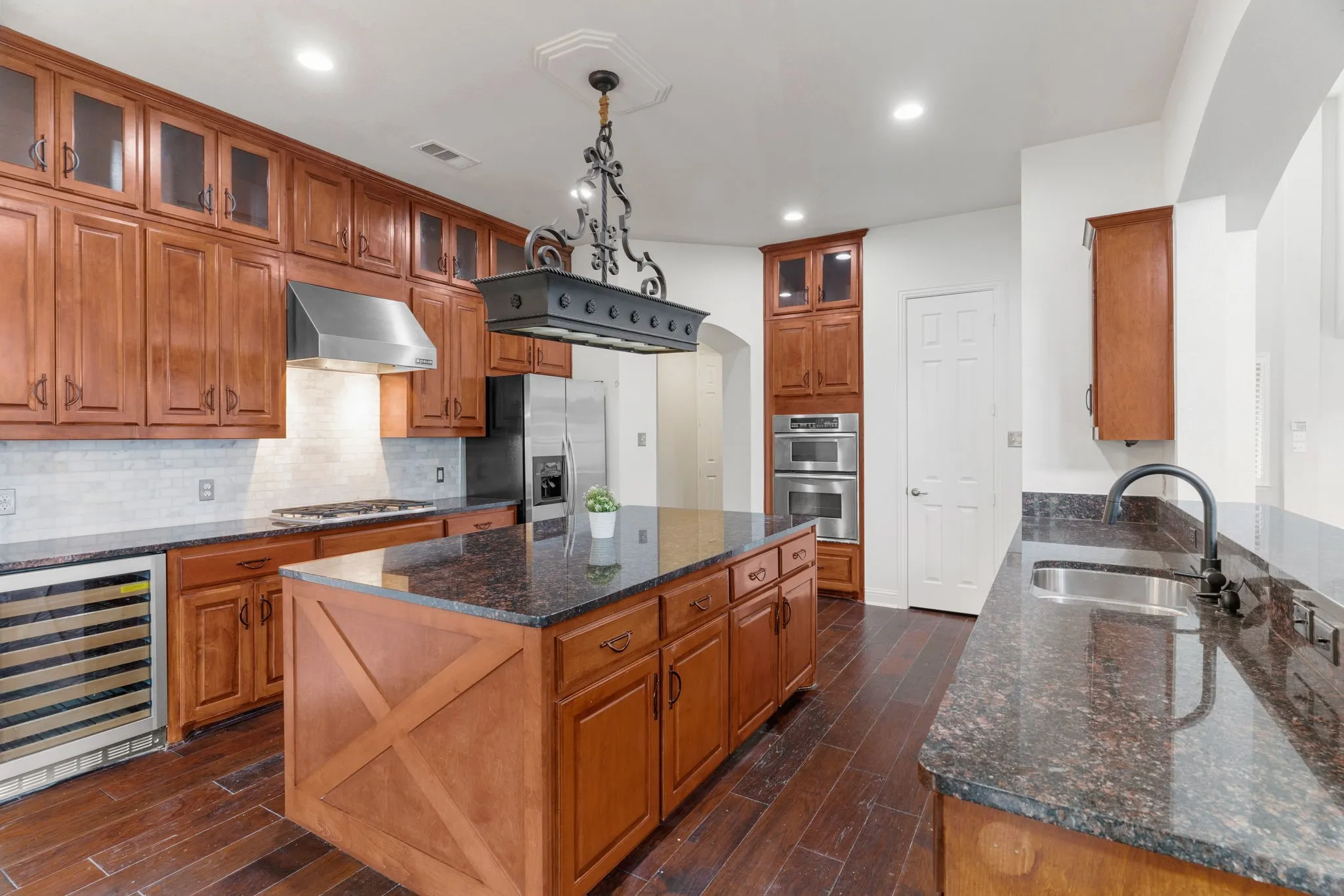 Updated kitchen includes newly added upper cabinets & hardware + new marble backsplash. The family chef will love the working space here!