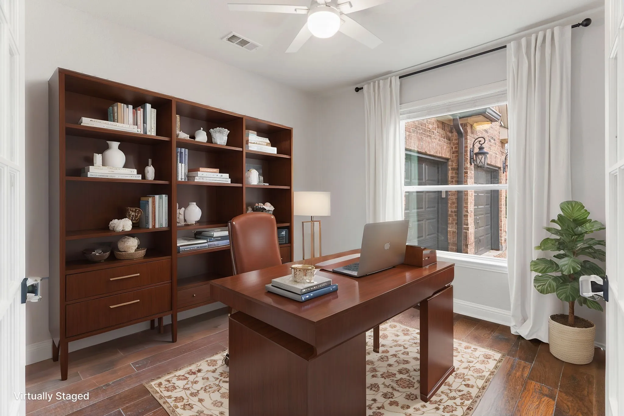 Dedicated home office has French doors for privacy.