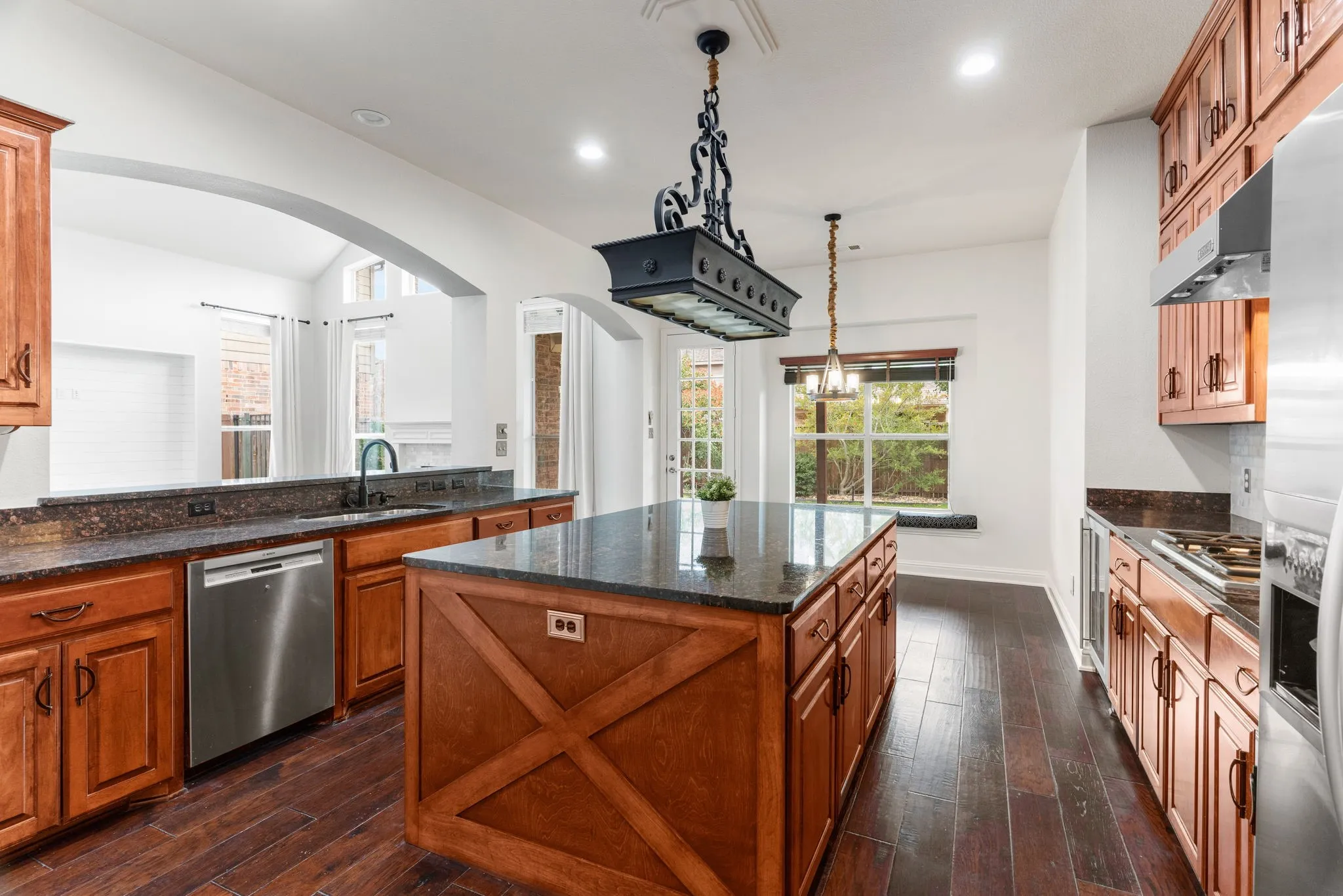 Note the end trim on the island & the iron pendant light over it.