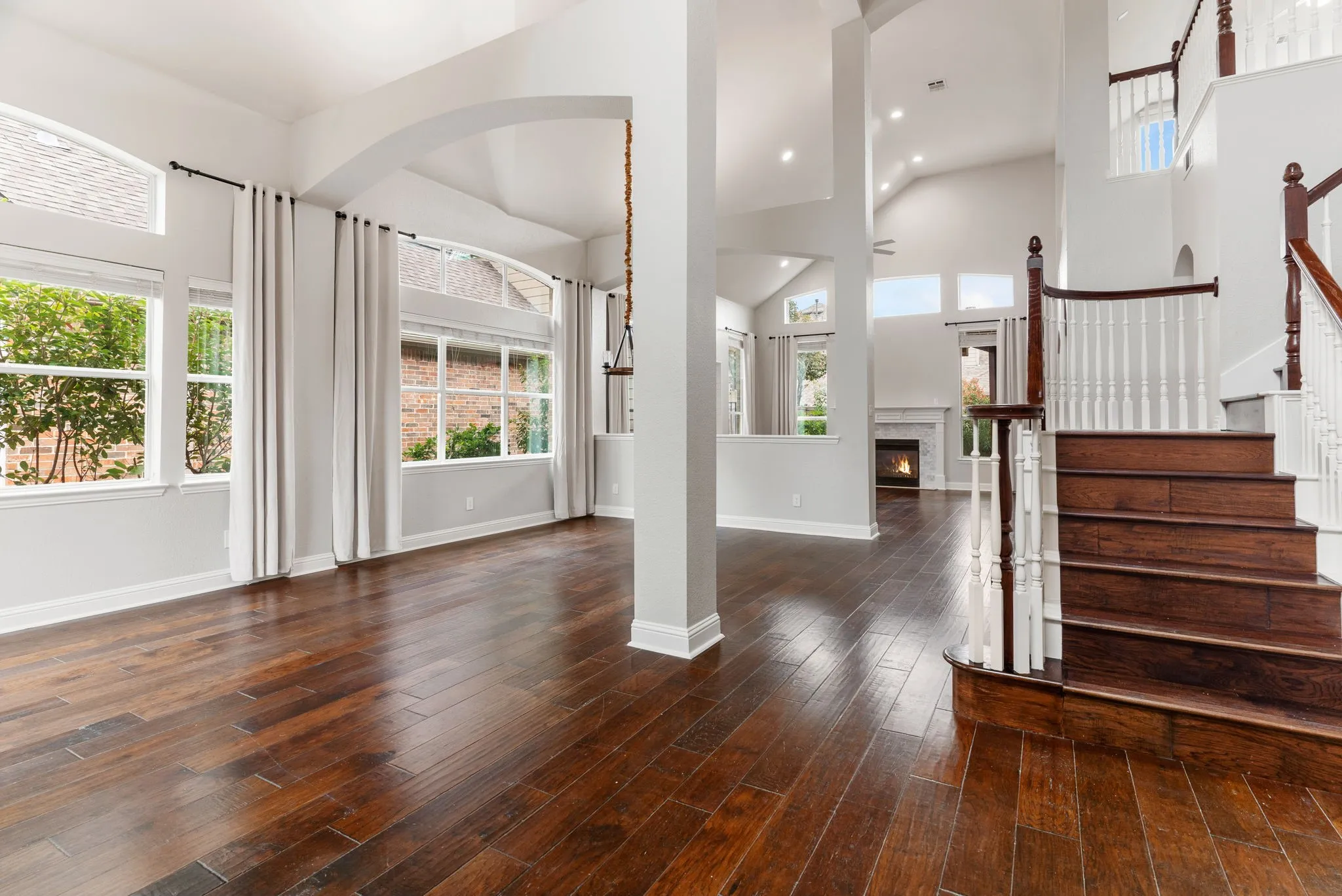 You'll love the dramatic architectural features ~ soaring ceilings, columns & double-stacked windows = lots of natural light! Hardwood floors & tile throughout this home---NO carpet!