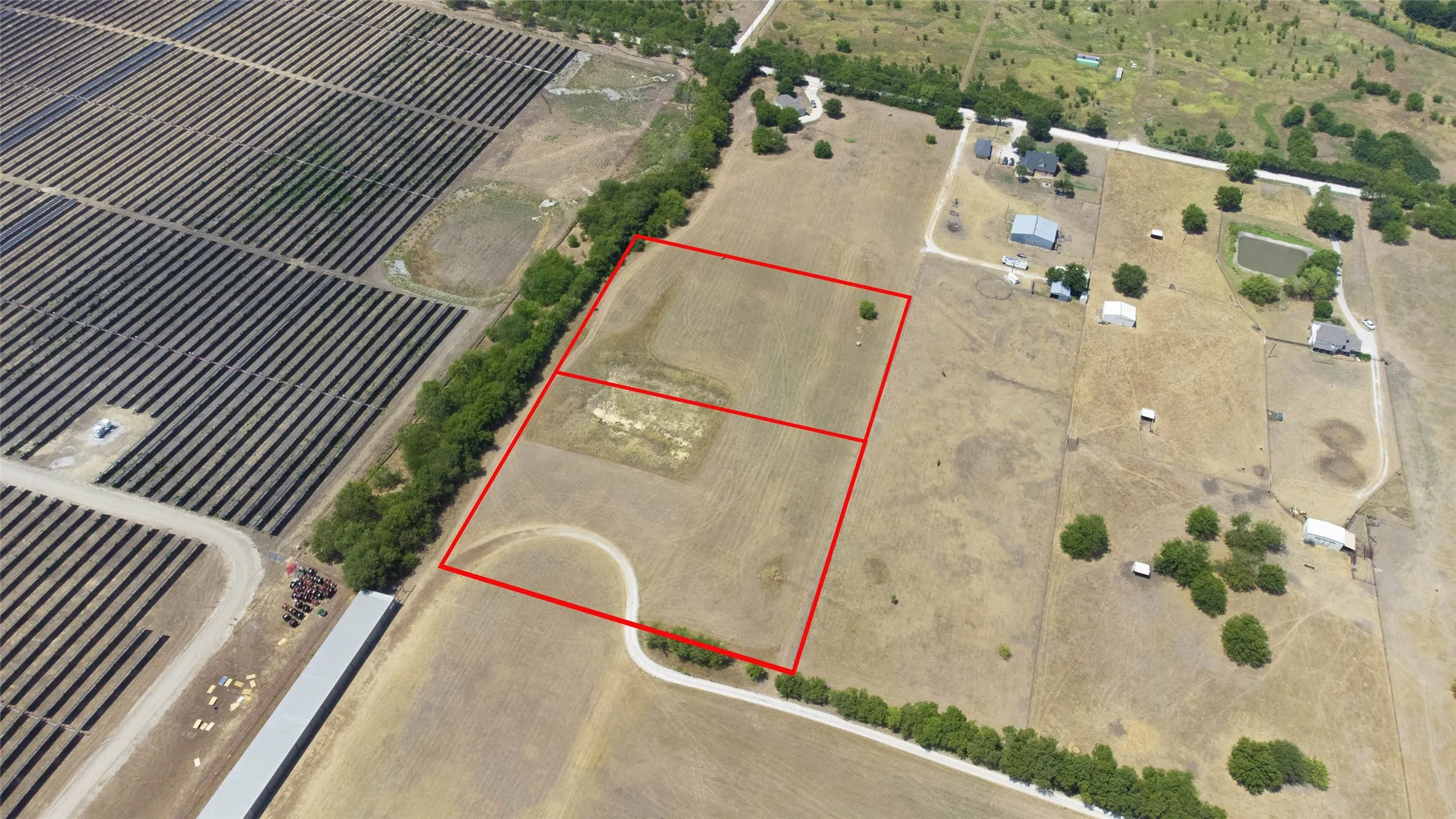 Aerial view of sparsely populated area featuring property boundaries highlighted