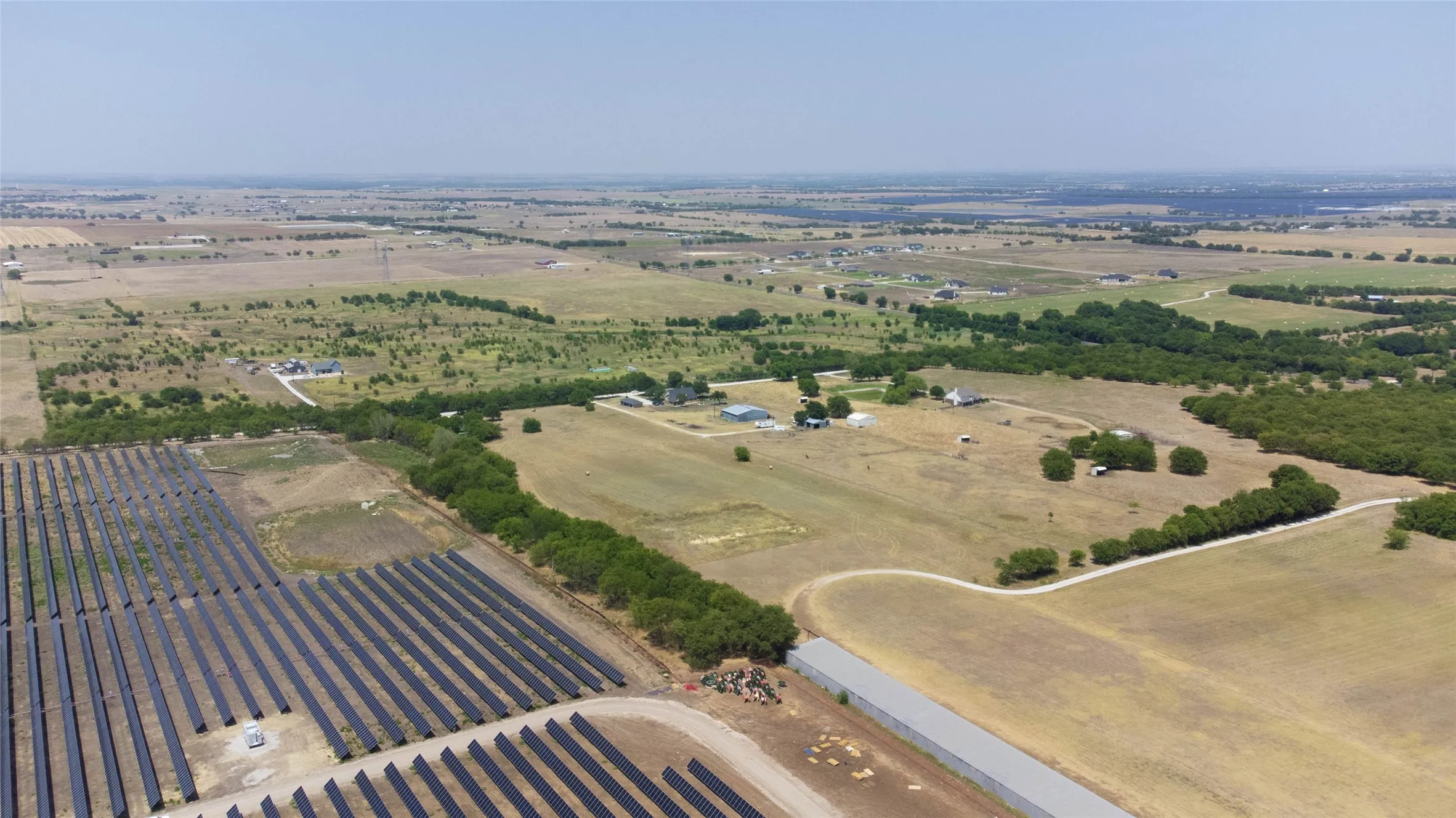 Aerial view of sparsely populated area featuring rows of crops