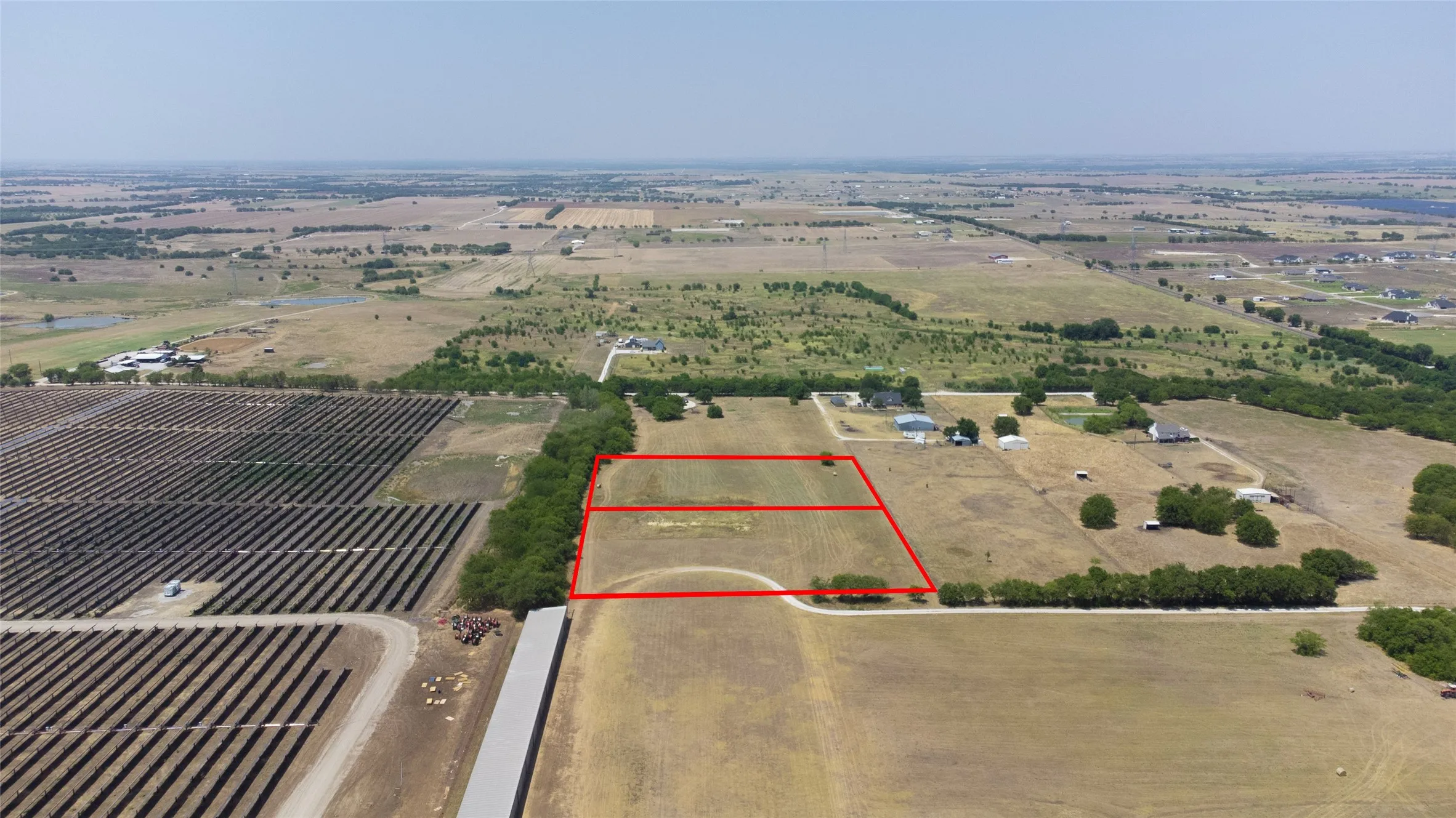 Overview of rural landscape with property parcel outlined and farmland