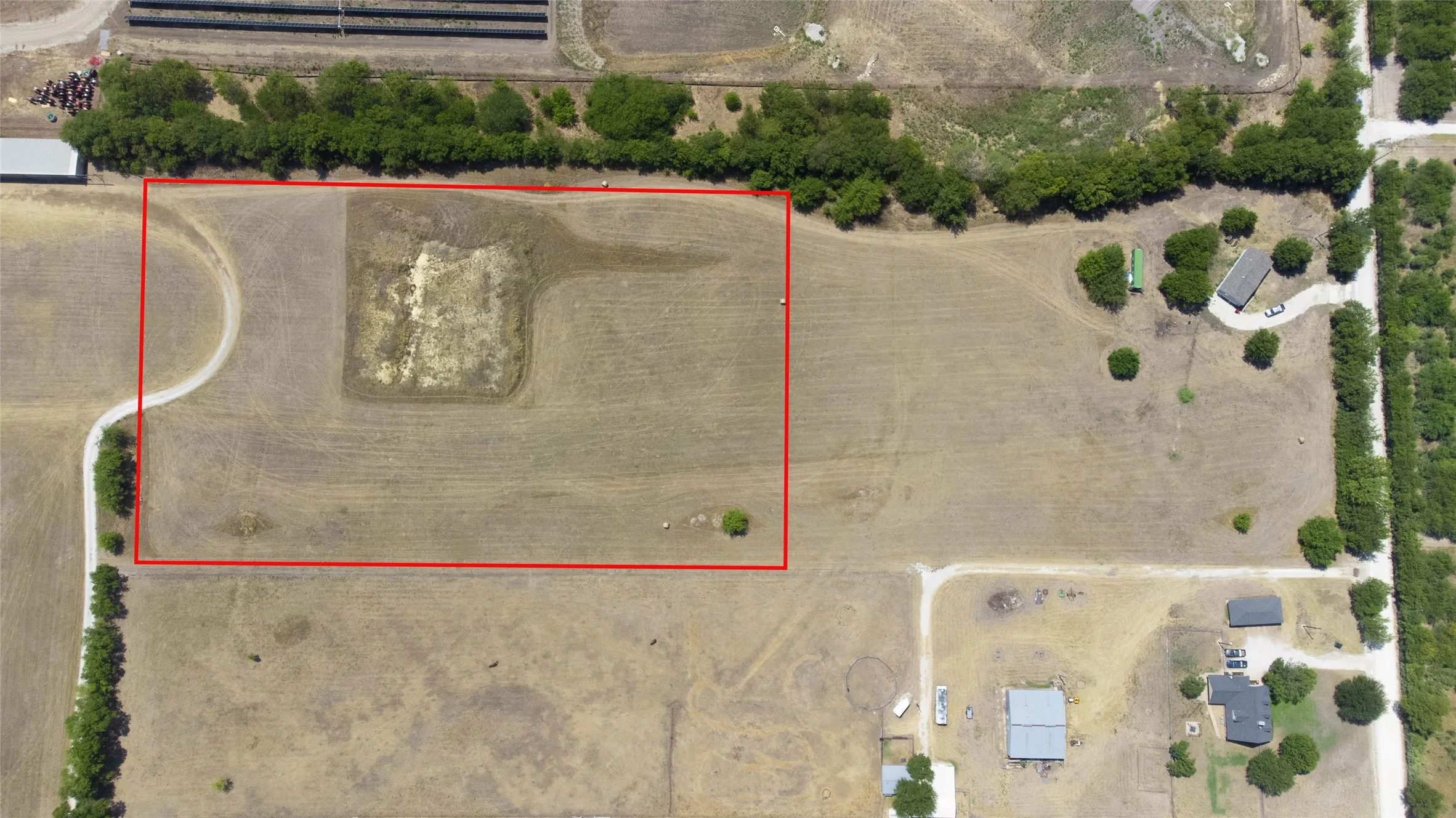 Aerial view of sparsely populated area with property boundaries highlighted