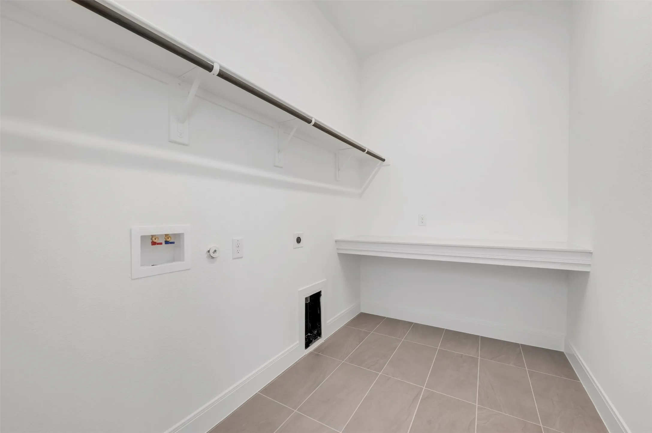 Tile flooring, integrated shelving, and a hanging rod