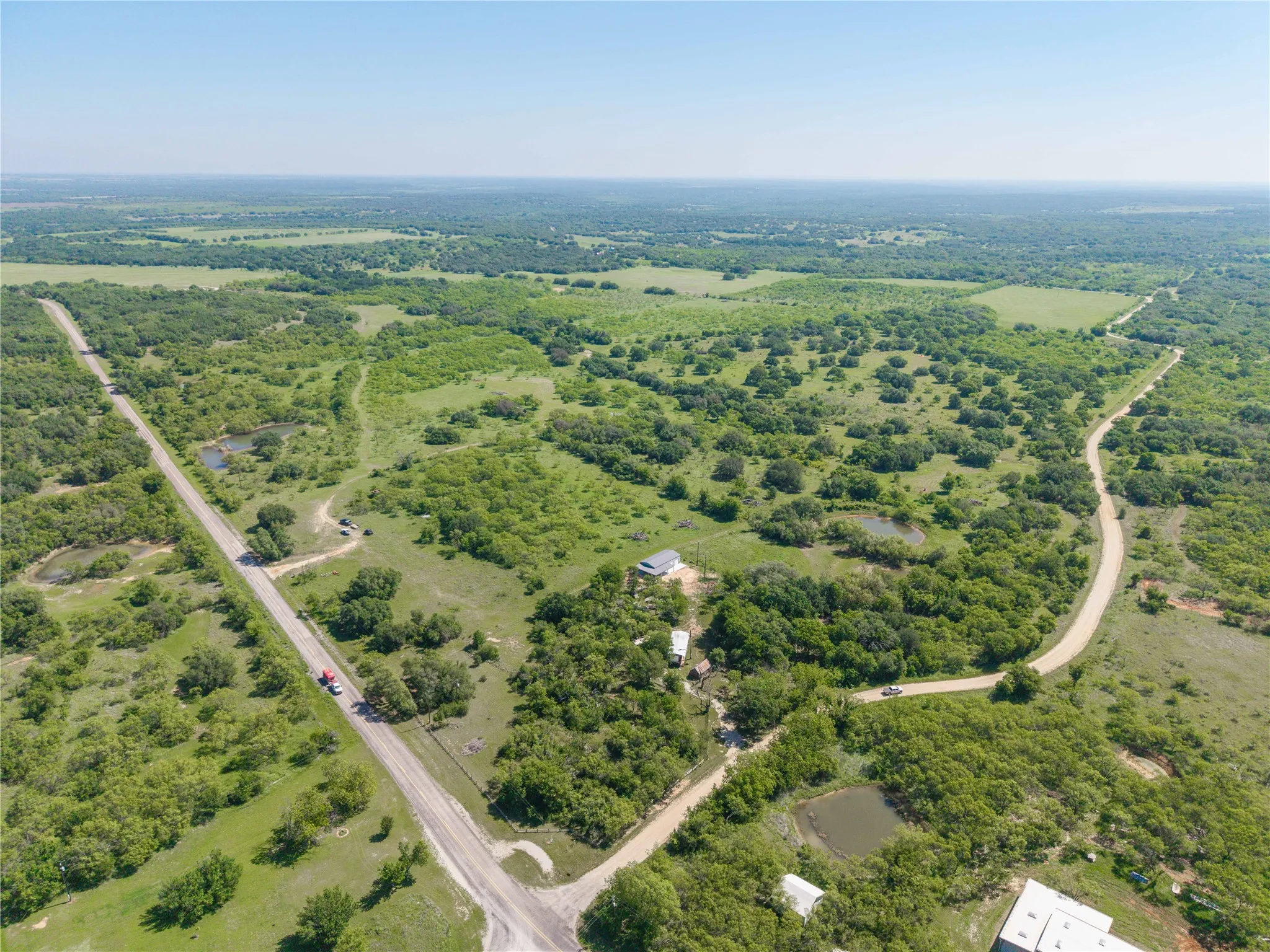 Expansive landscape featuring diverse vegetation and clear skies