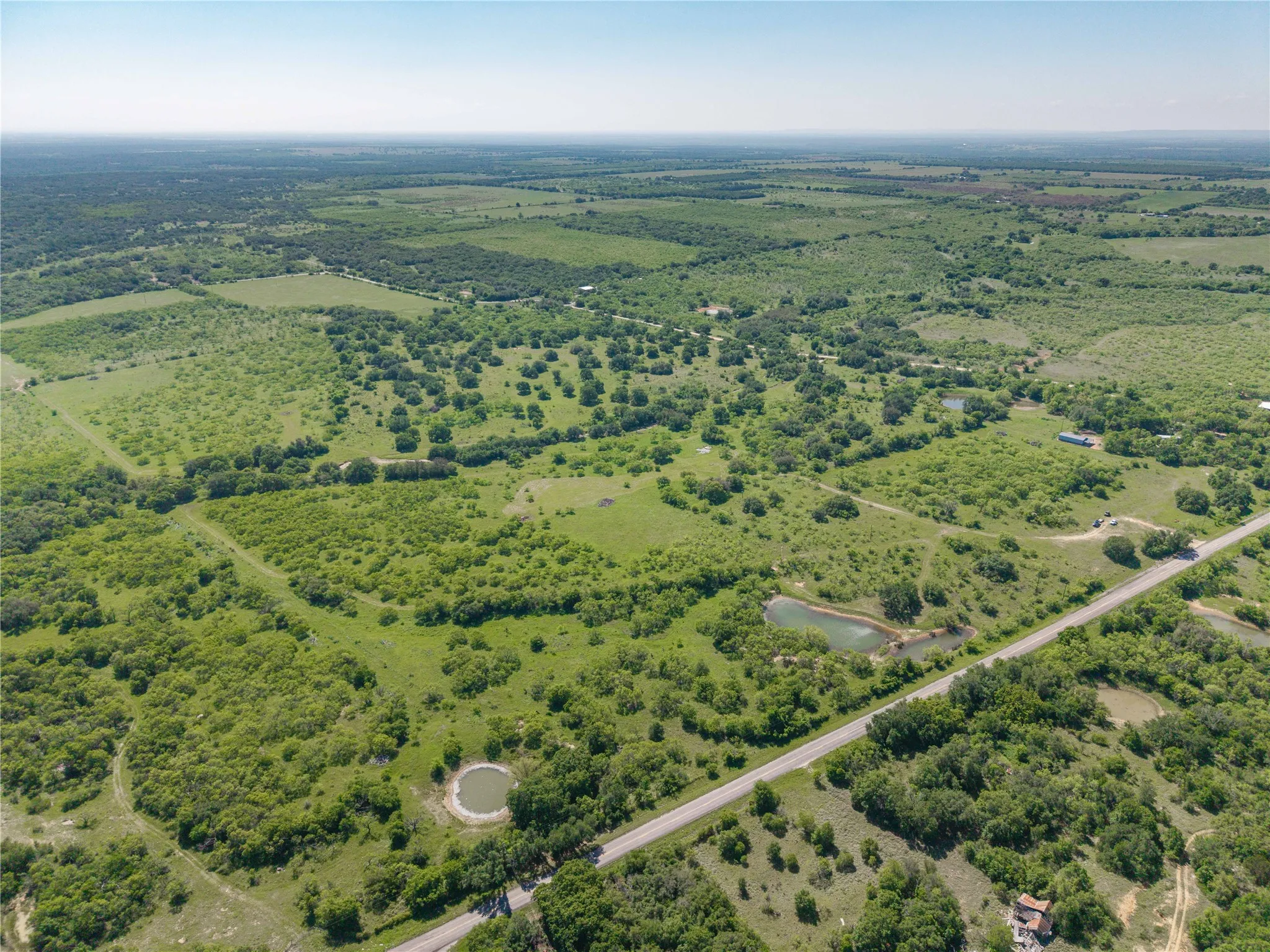 Expansive rural landscape featuring extensive green foliage and open areas