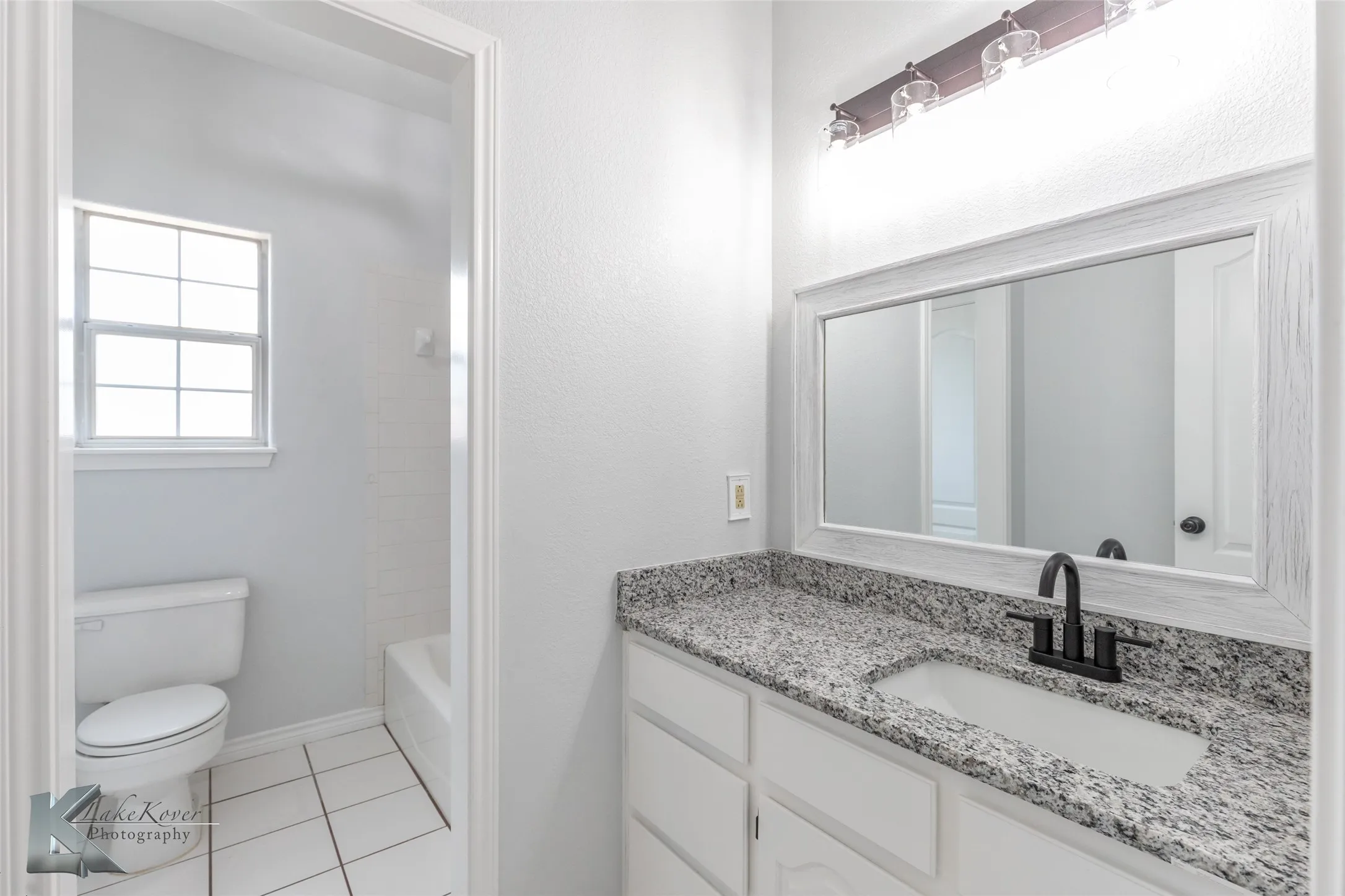 Full bathroom with vanity, tile patterned floors, and tub / shower combination