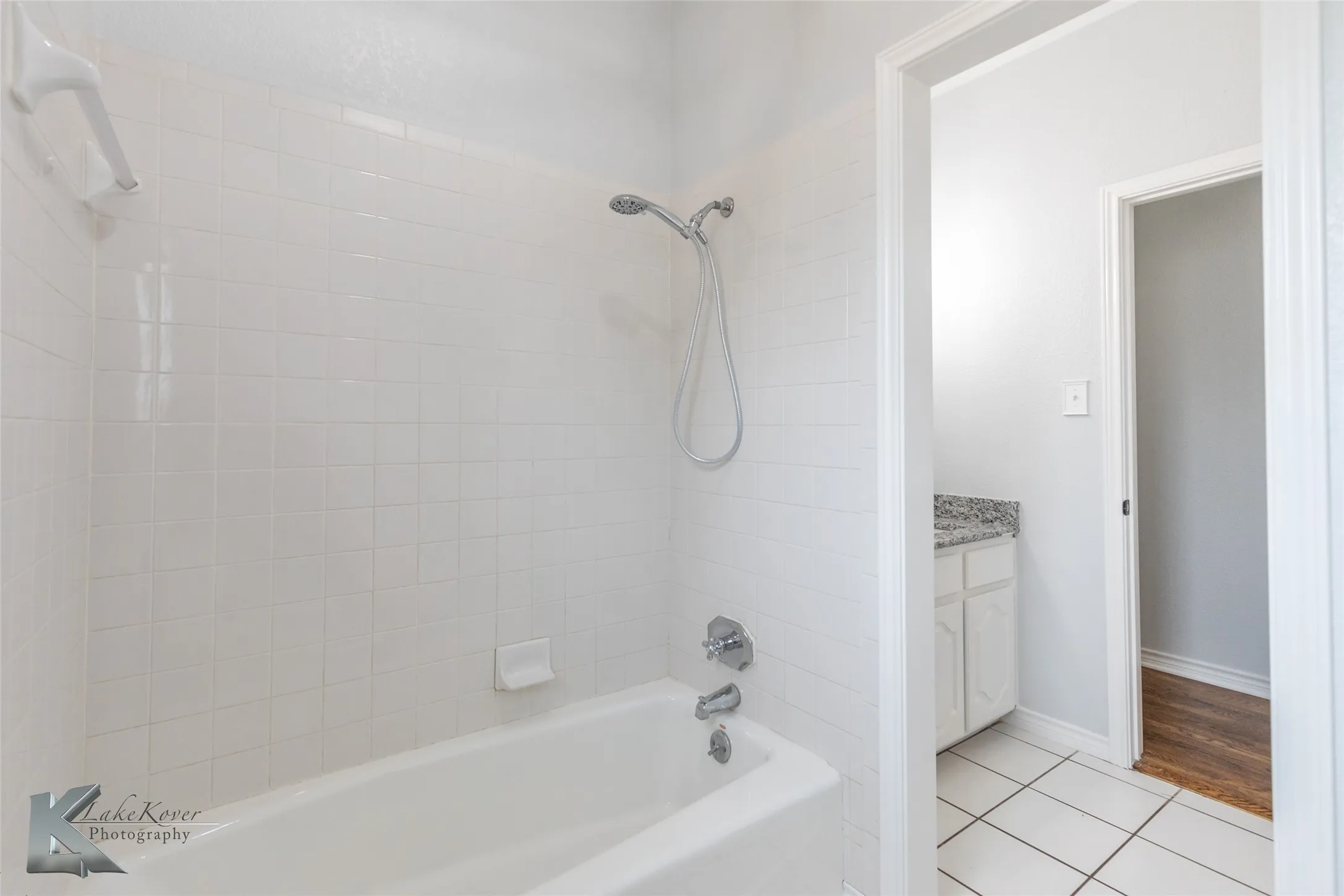 Full bath with shower / bathtub combination, vanity, and tile patterned floors