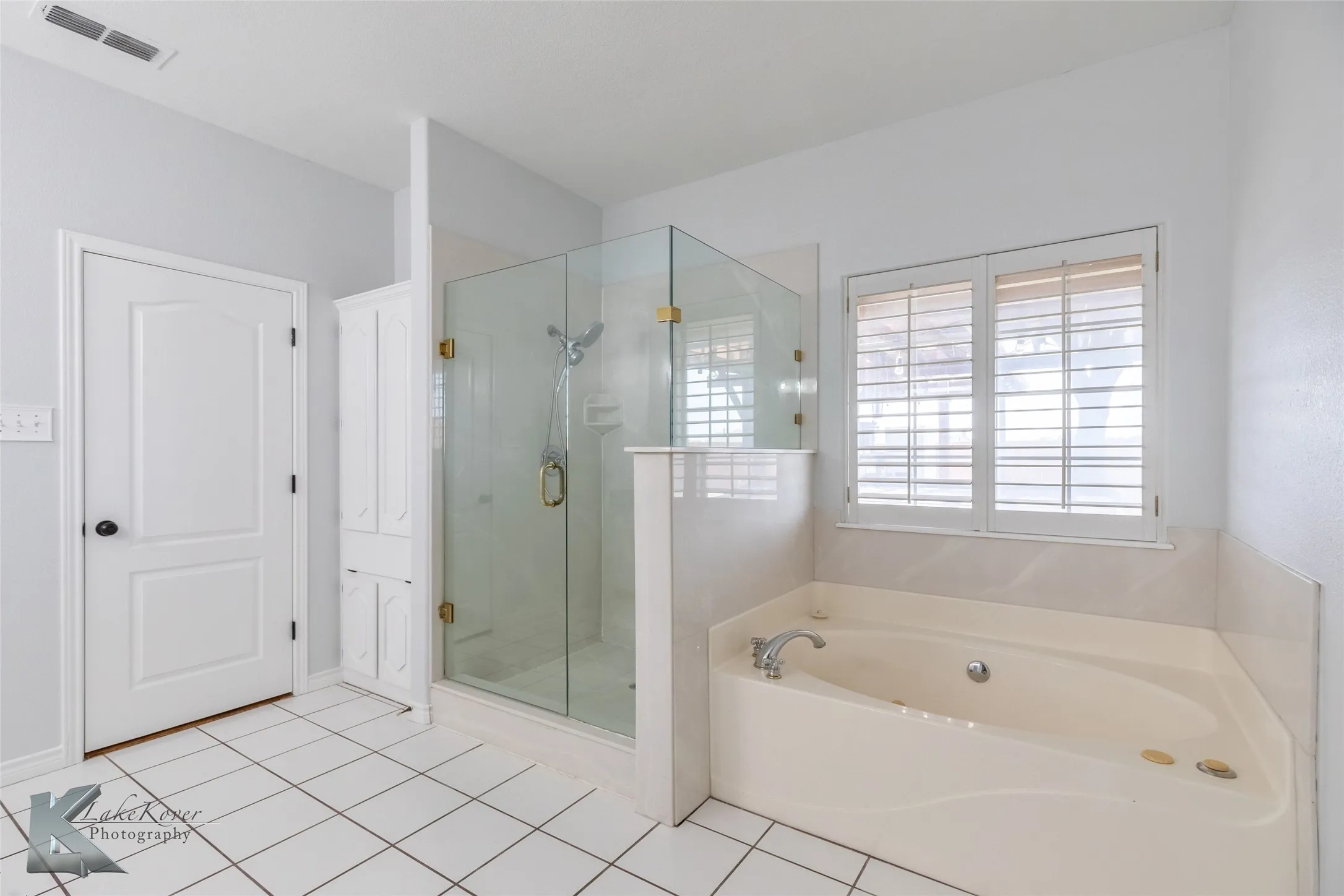 Bathroom with a bath, a stall shower, and tile patterned flooring