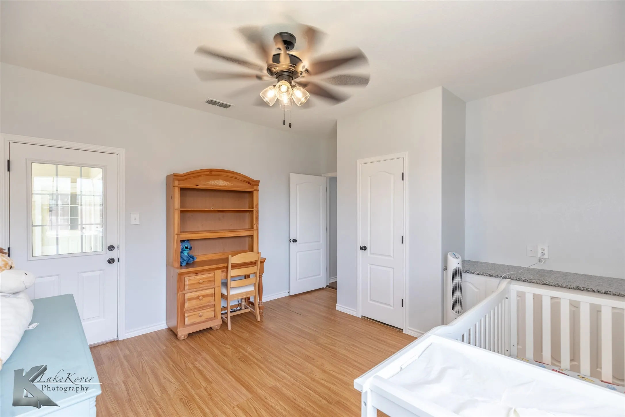 Bedroom with light wood finished floors and a ceiling fan