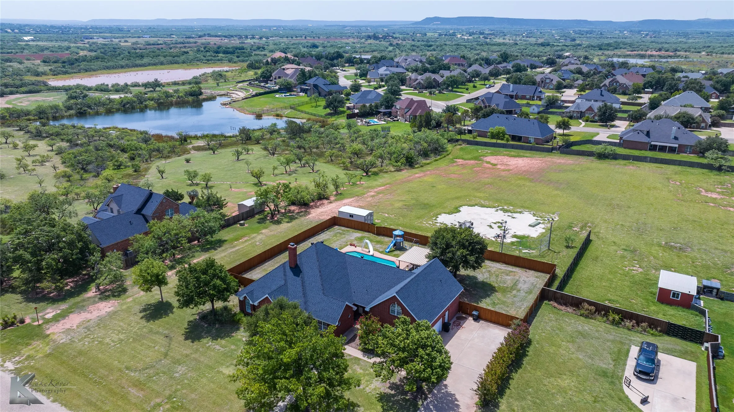Aerial perspective of suburban area featuring a large body of water
