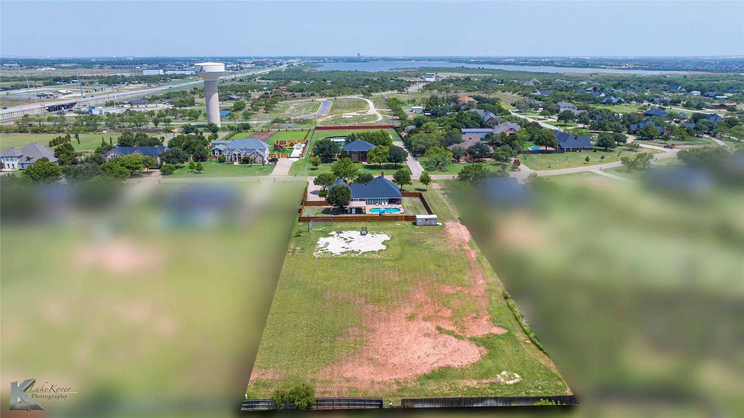 Aerial view of residential area featuring a large body of water