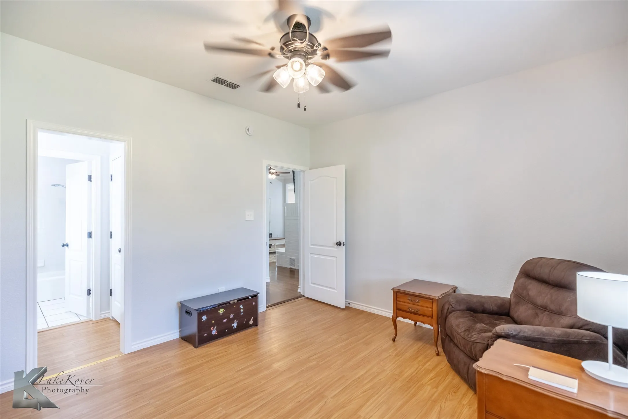Living area featuring a ceiling fan and light wood-type flooring