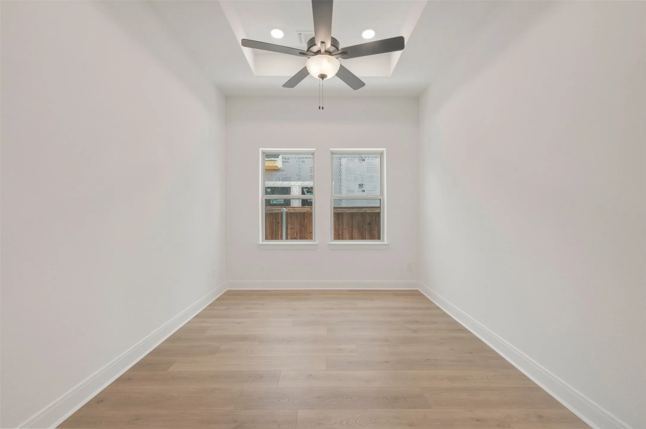 Recessed ceiling with integrated lighting and a contemporary ceiling fan