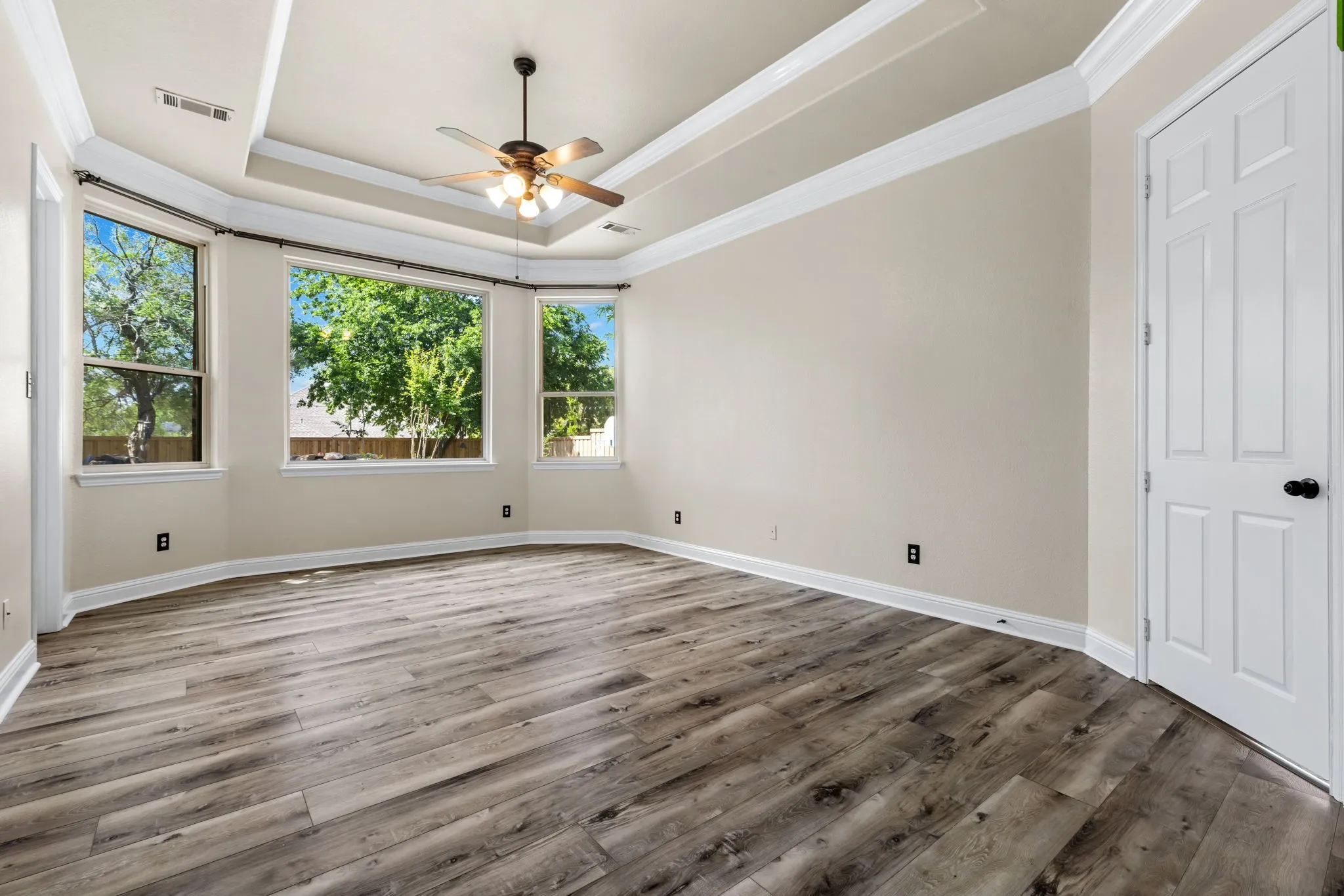 Spacious Primary bedroom with picture window overlooking the backyard​​‌​​​​‌​​‌‌​‌‌​​​‌‌​‌​‌​‌​​​‌​​ oasis