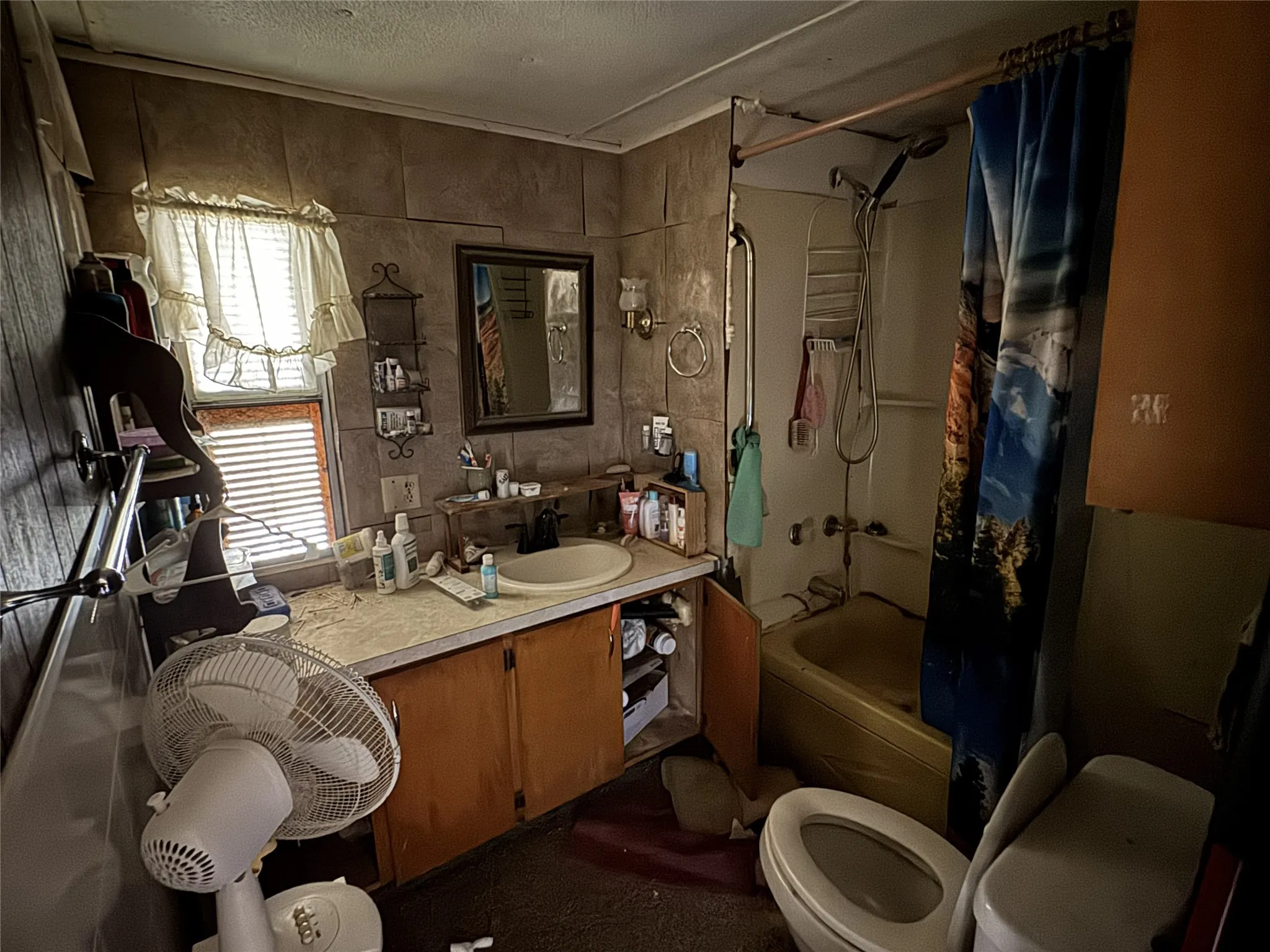 Full bathroom with vanity, shower / bathtub combination with curtain, and a textured ceiling