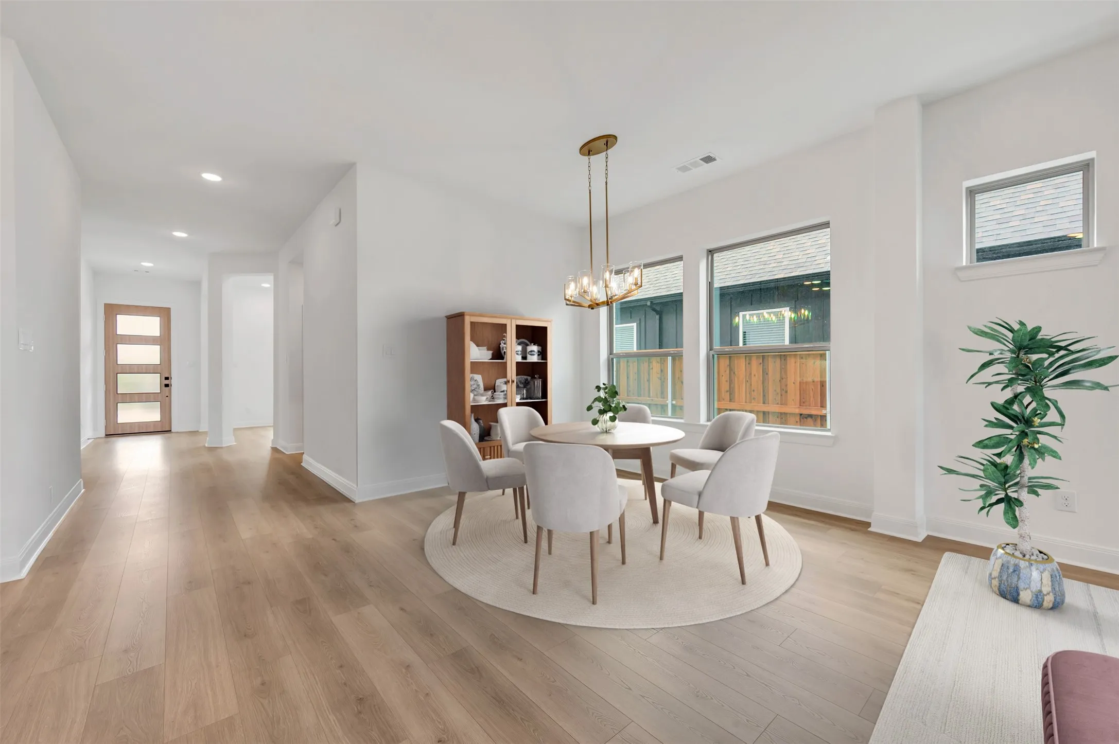 Open-concept dining area with wood-finish flooring