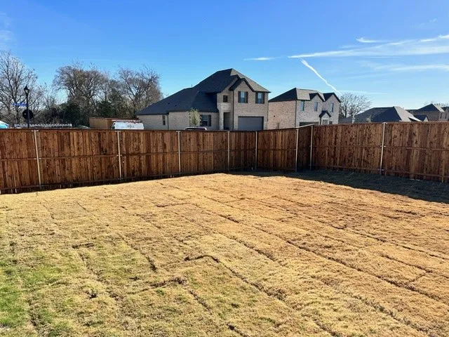 Fenced backyard with a residential view