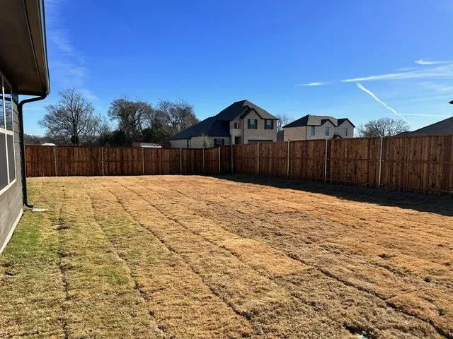 View of fenced backyard