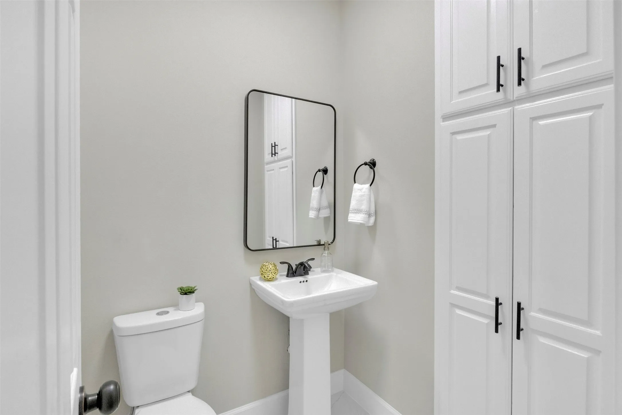 Bathroom with toilet and baseboards