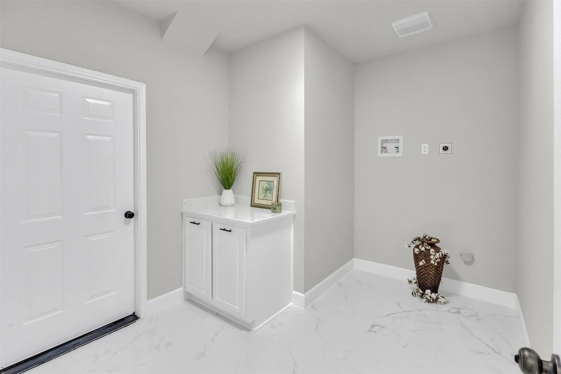 Laundry area featuring light marble finish flooring, washer hookup, and hookup for an electric dryer