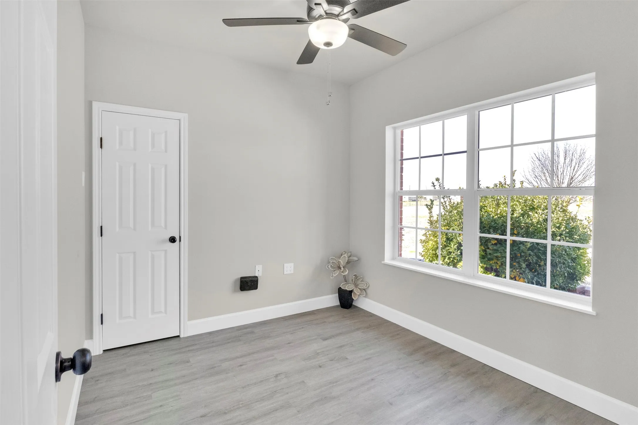 Spare room featuring ceiling fan and light wood-type flooring