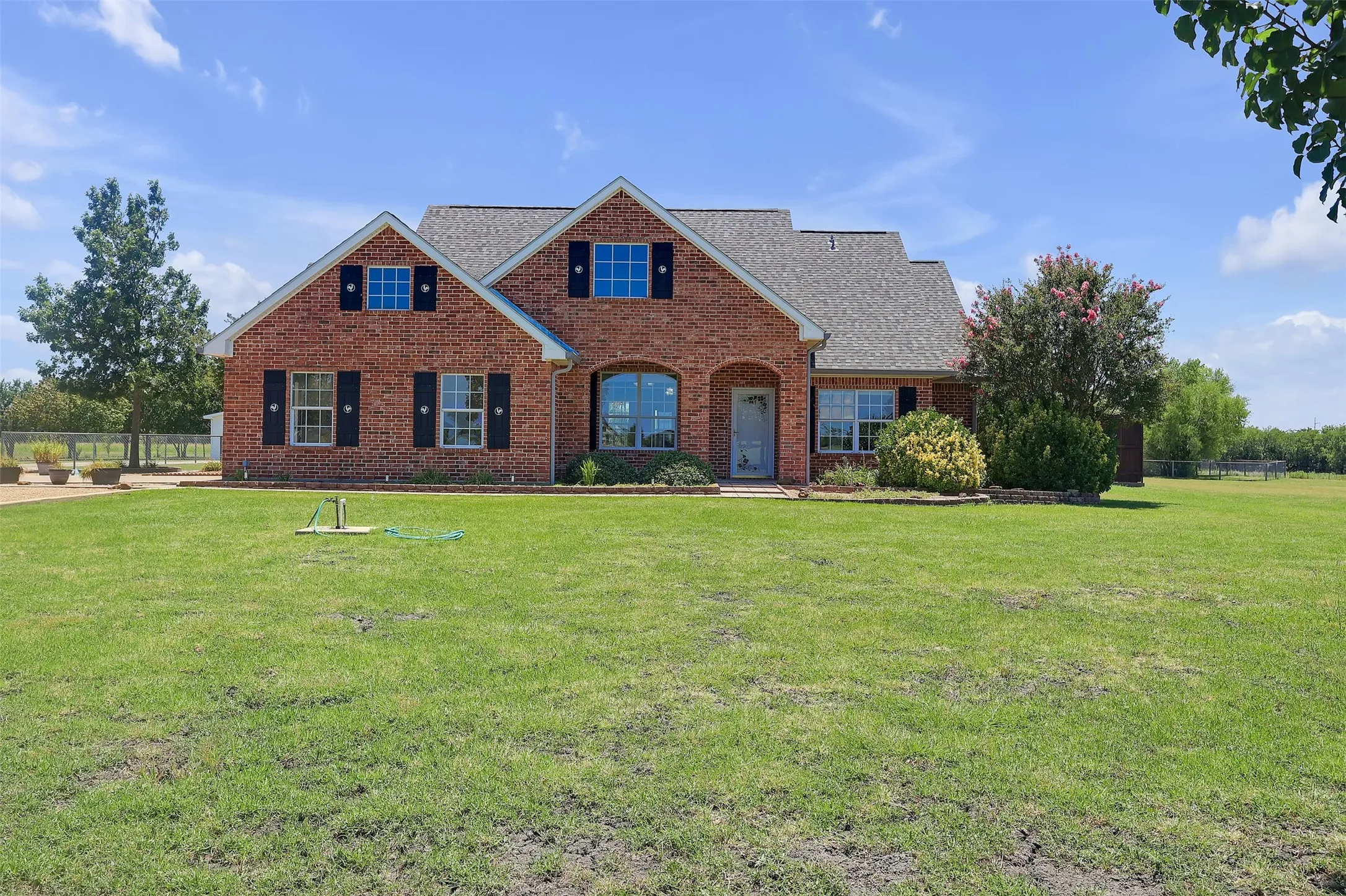 Traditional-style home with brick siding