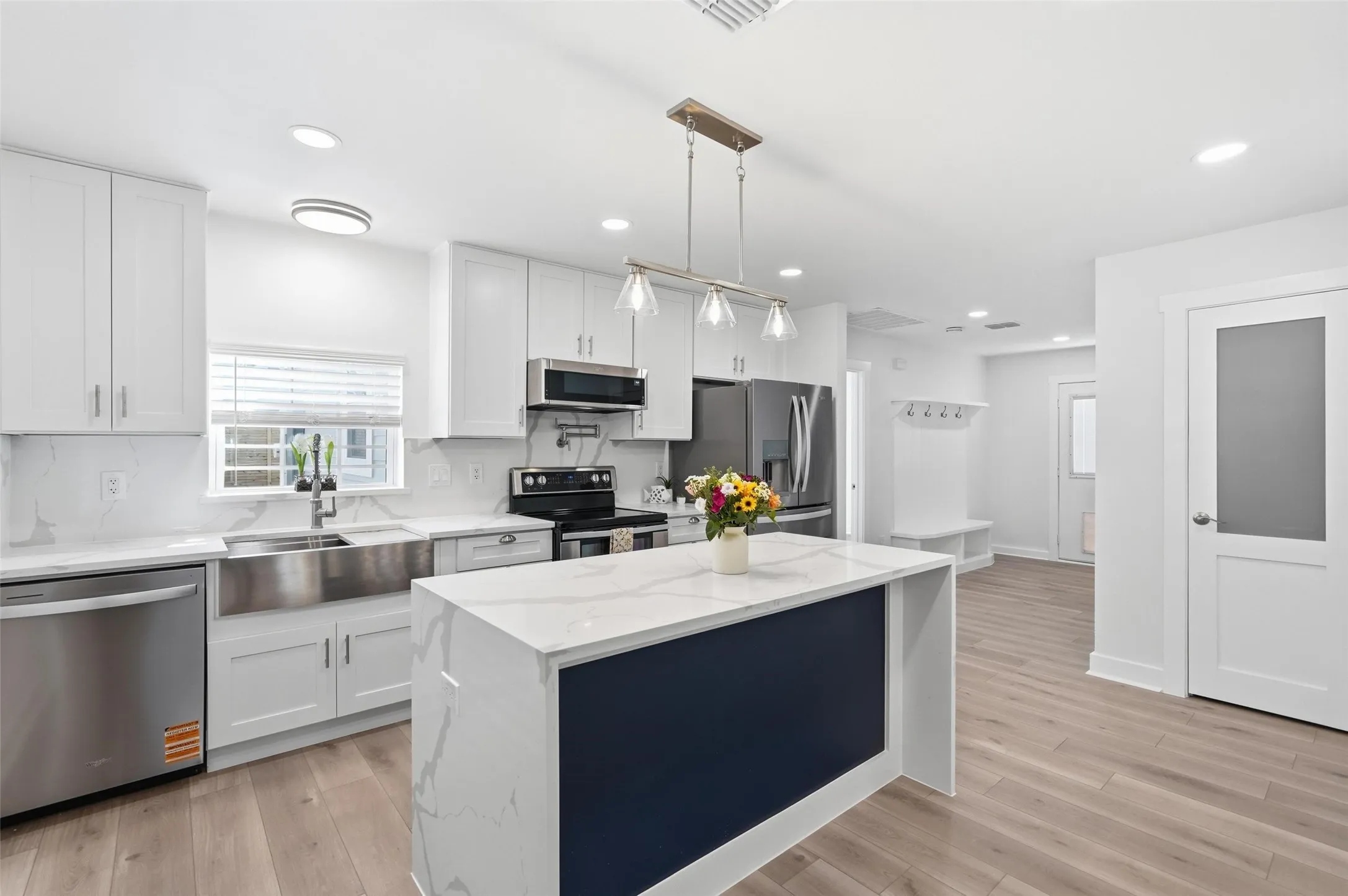 Gourmet kitchen featuring a large island and stunning quartz countertops, perfect for cooking and entertaining.