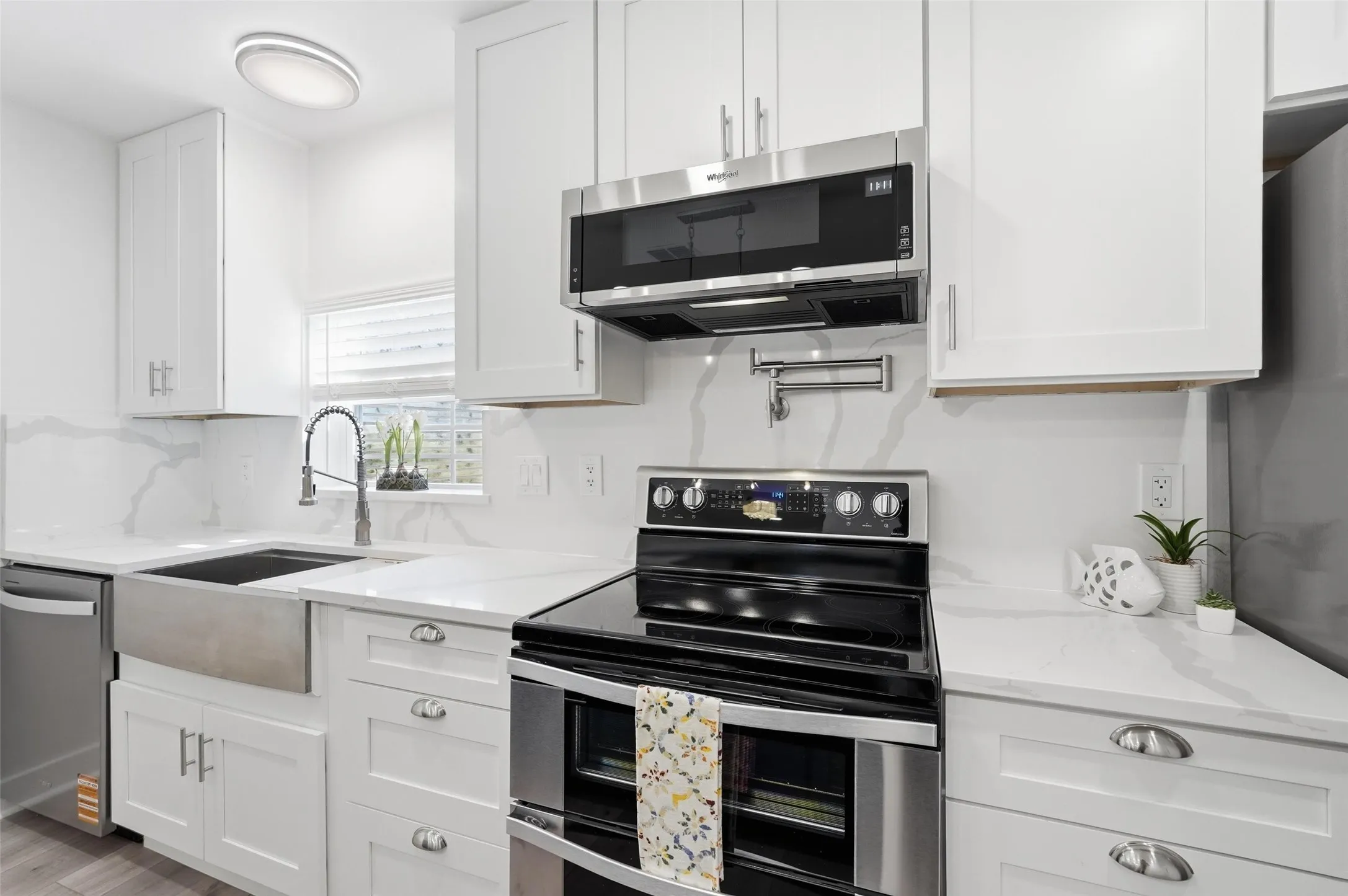 Sleek stainless steel appliances complete the modern kitchen.
