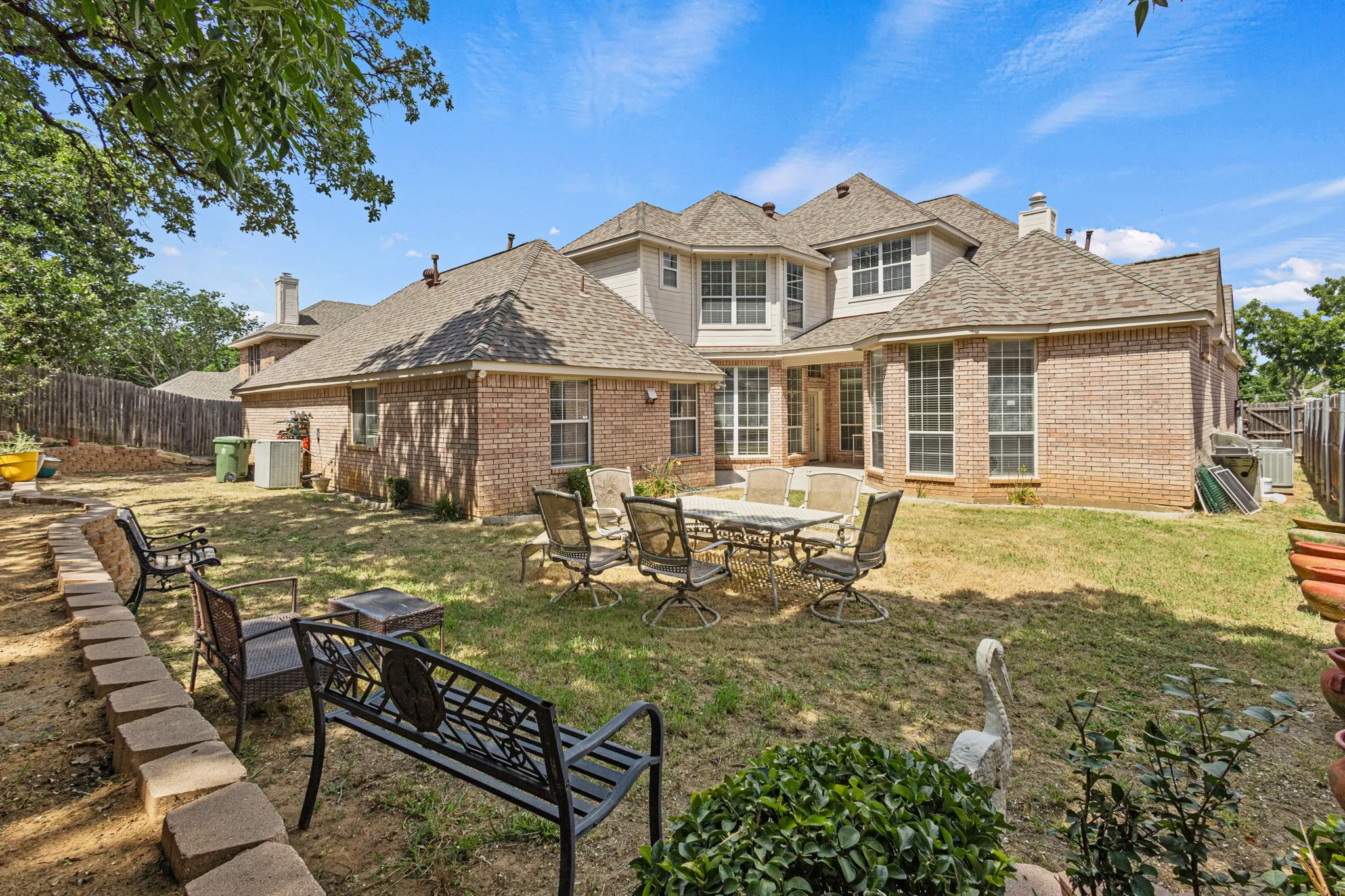 Rear view of property with a yard and a patio area