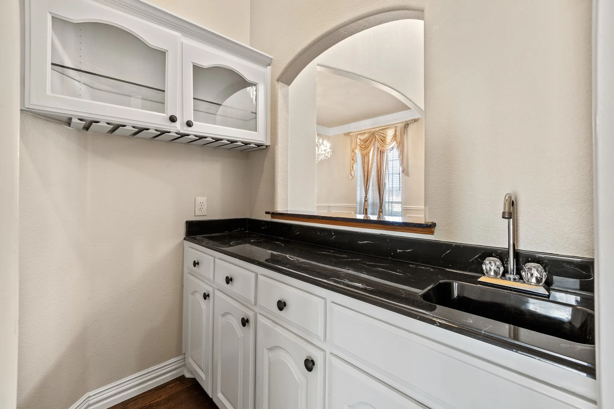 Full wet bar with vanity and hardwood / wood-style flooring