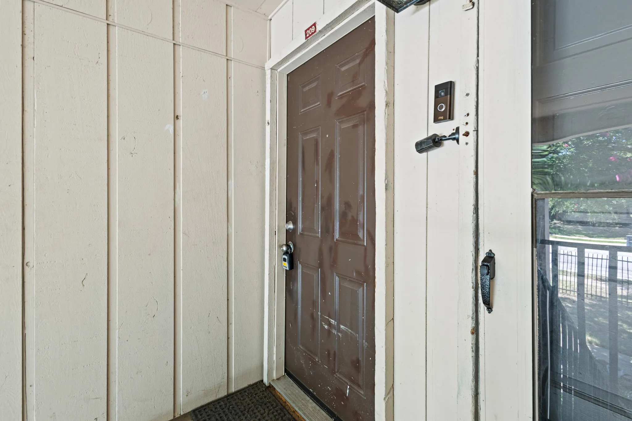 Property entrance featuring board and batten siding