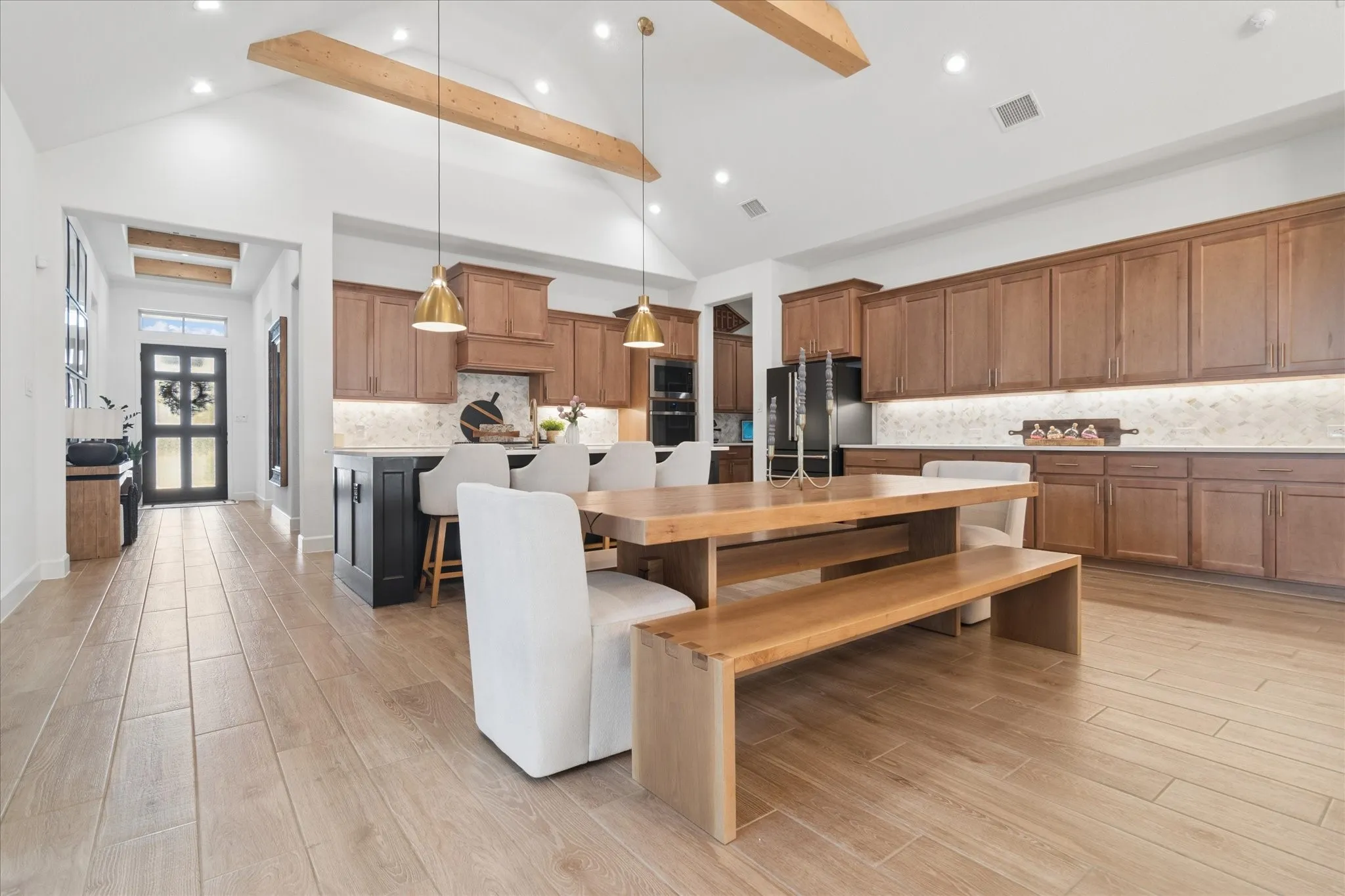Custom lighting throughout the home. Stained wood beams in kitchen, dining and main living area. Beautiful wood flooring. So much counterspace for food prep and entertaining.