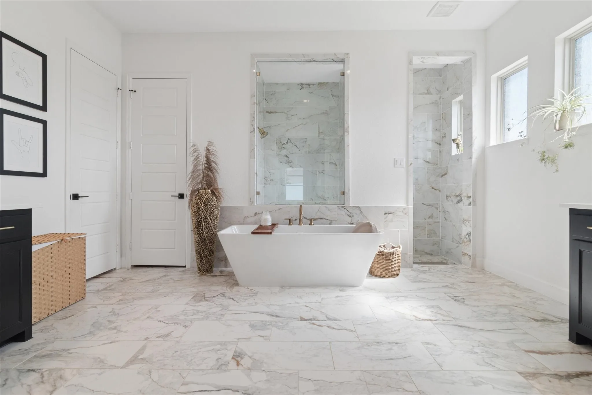 Beautiful spa like primary bathroom. Double vanities, stand alone soaking bath tub, huge walk in shower with glass enclosure for natural light from windows. Travertine flooring and on shower walls. Closet door on the right goes directly through closet to laundry room.