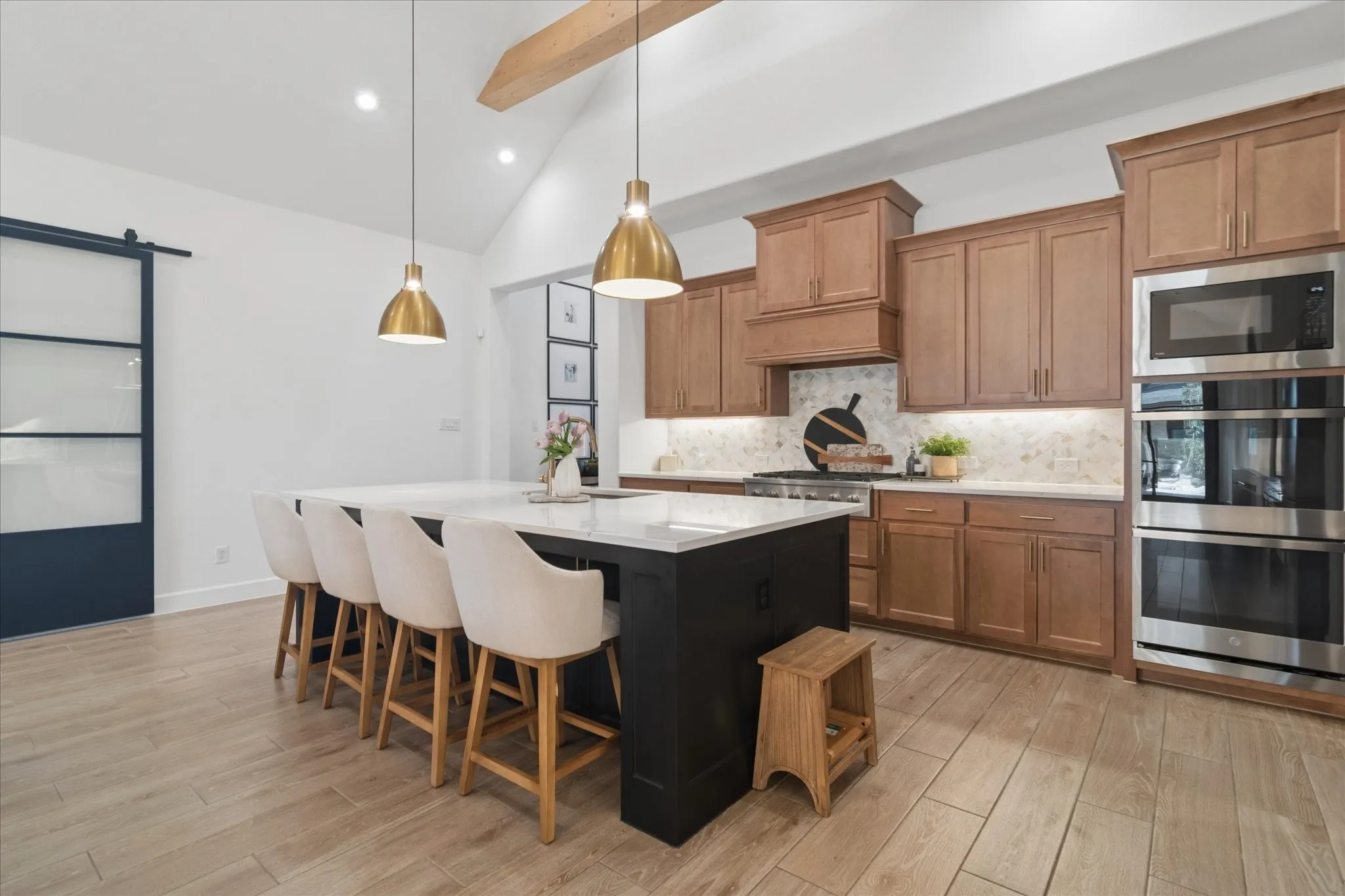 Oversized island with painted accent finish. Kitchen offers double oven, high end appliances.