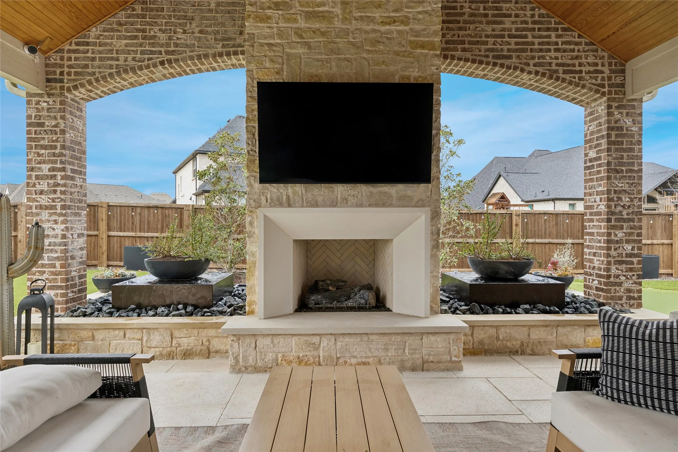 Arched openings on either side of the fireplace offer natural light, water and fire features. Serene area for relaxing and enjoying beautiful Texas sunsets!