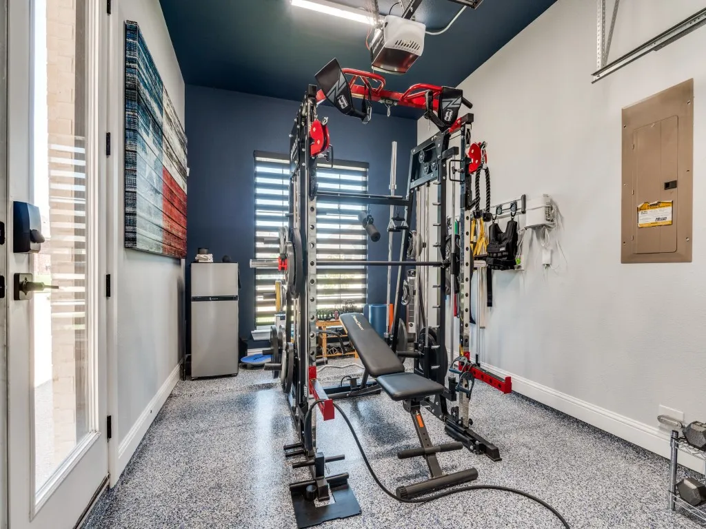 Exercise area featuring electric panel and baseboards