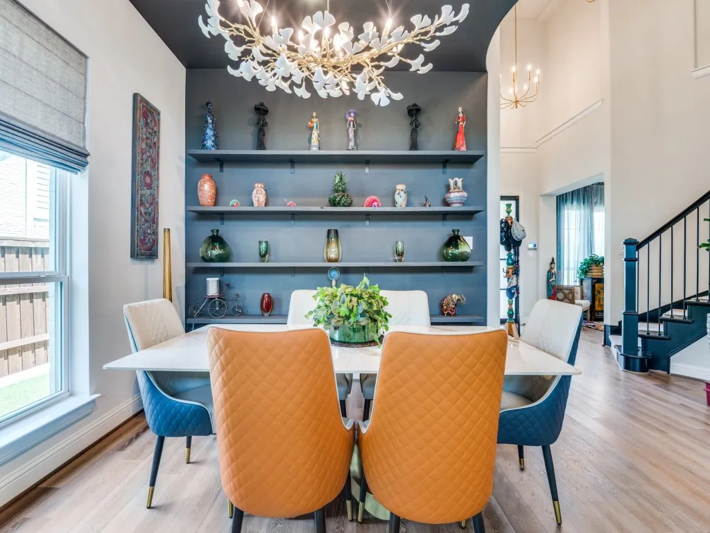 Dining space with a chandelier, stairway, and wood finished floors