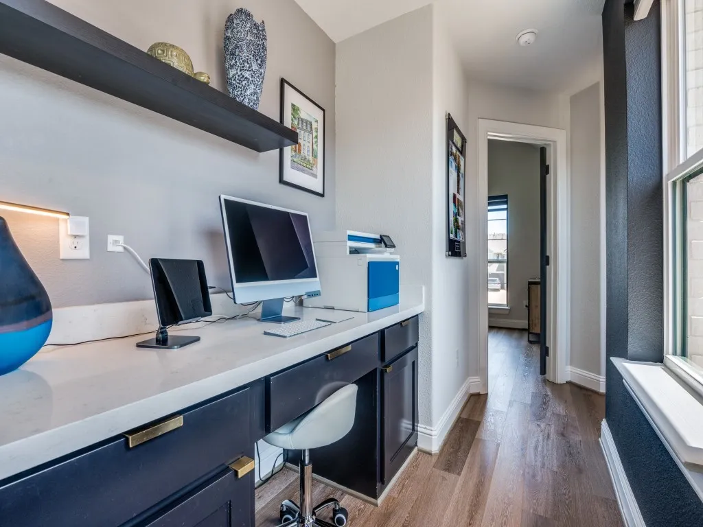 Home office with dark wood-style floors and baseboards