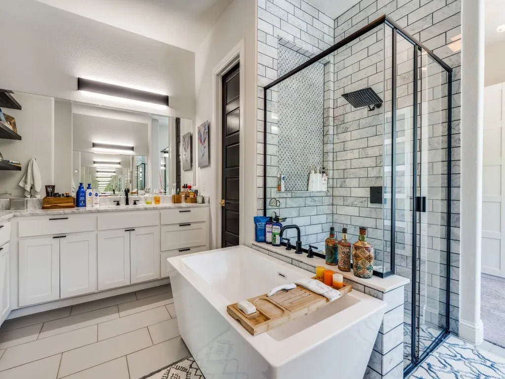 Full bathroom with a freestanding tub, a stall shower, and vanity