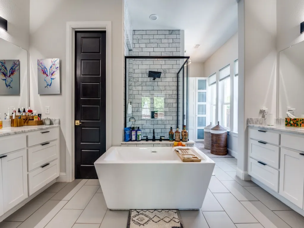 Bathroom with vanity, a soaking tub, a stall shower, and tile patterned floors